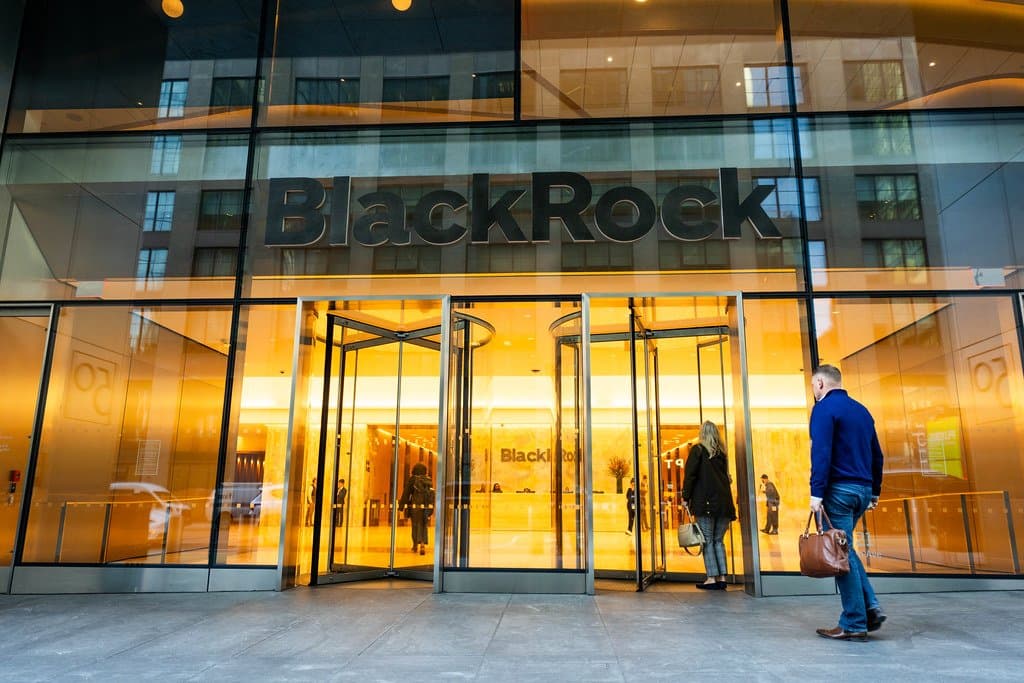 an entrance to a glass building