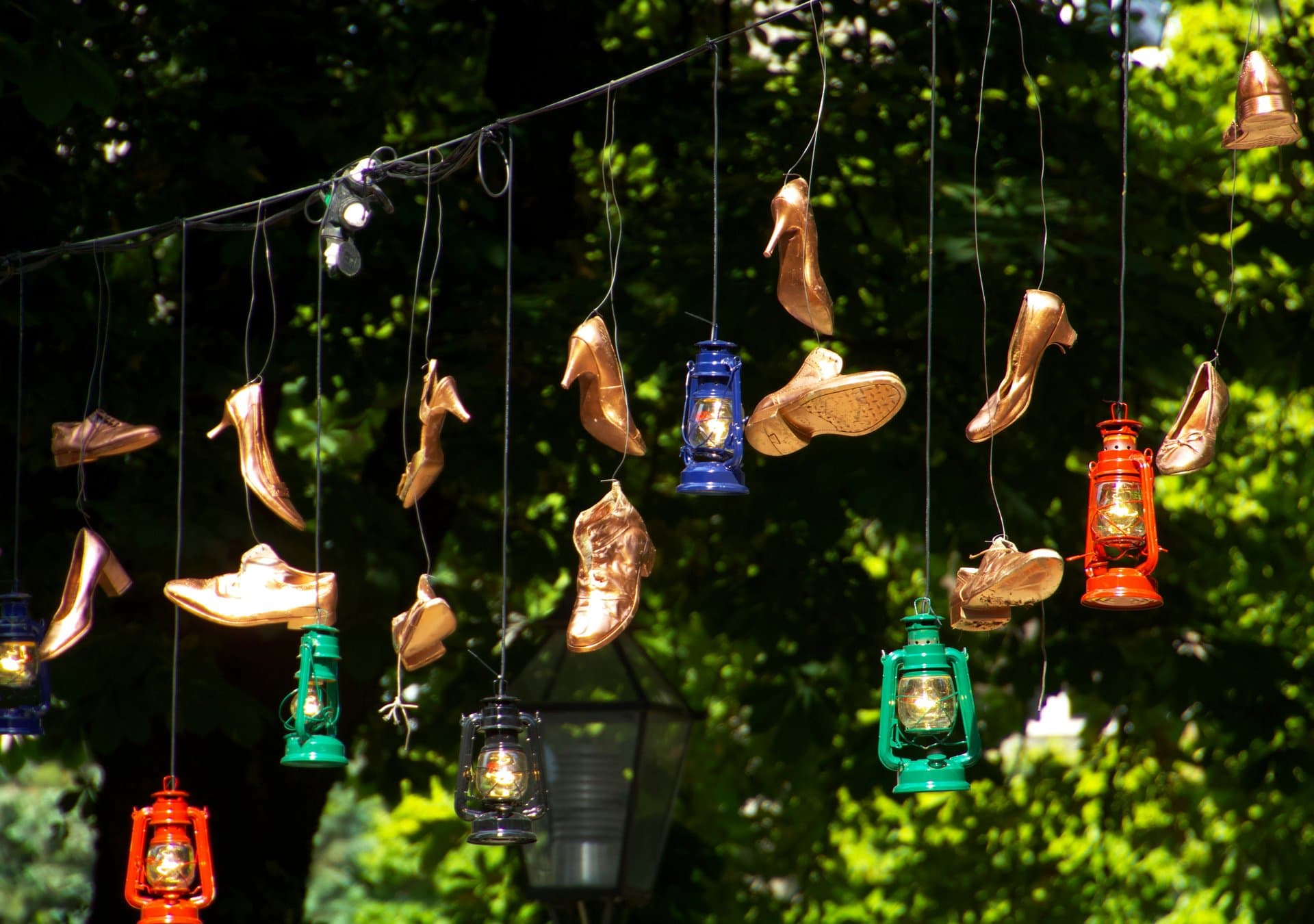 a set of golden shoes hanging off a rope