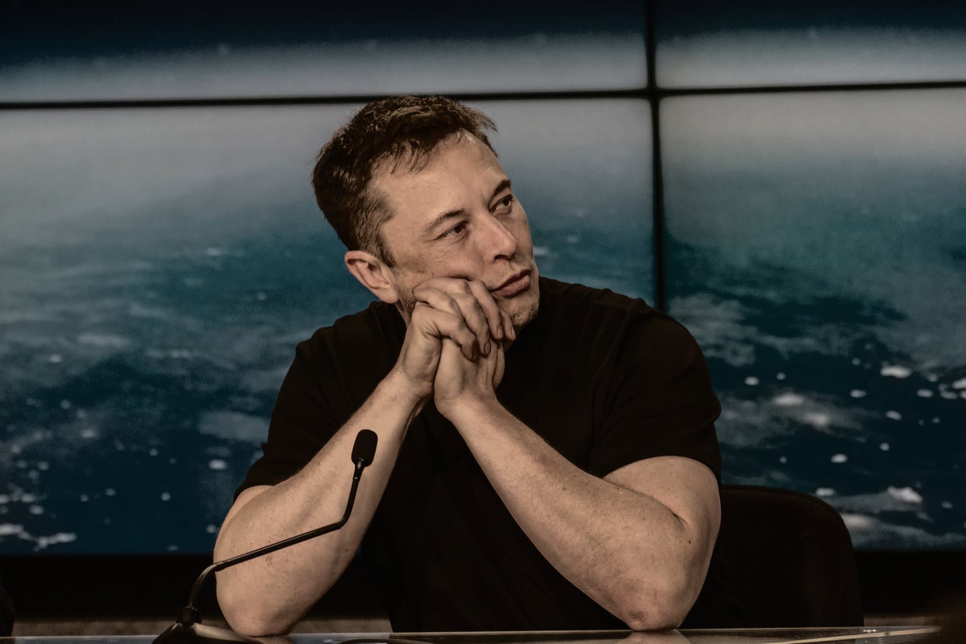 a man sitting in front of a mic