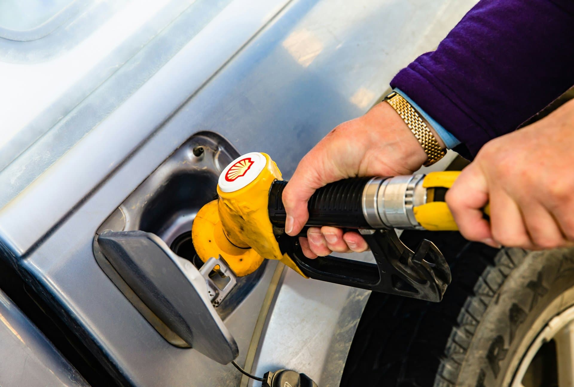 a person holding a gas injector