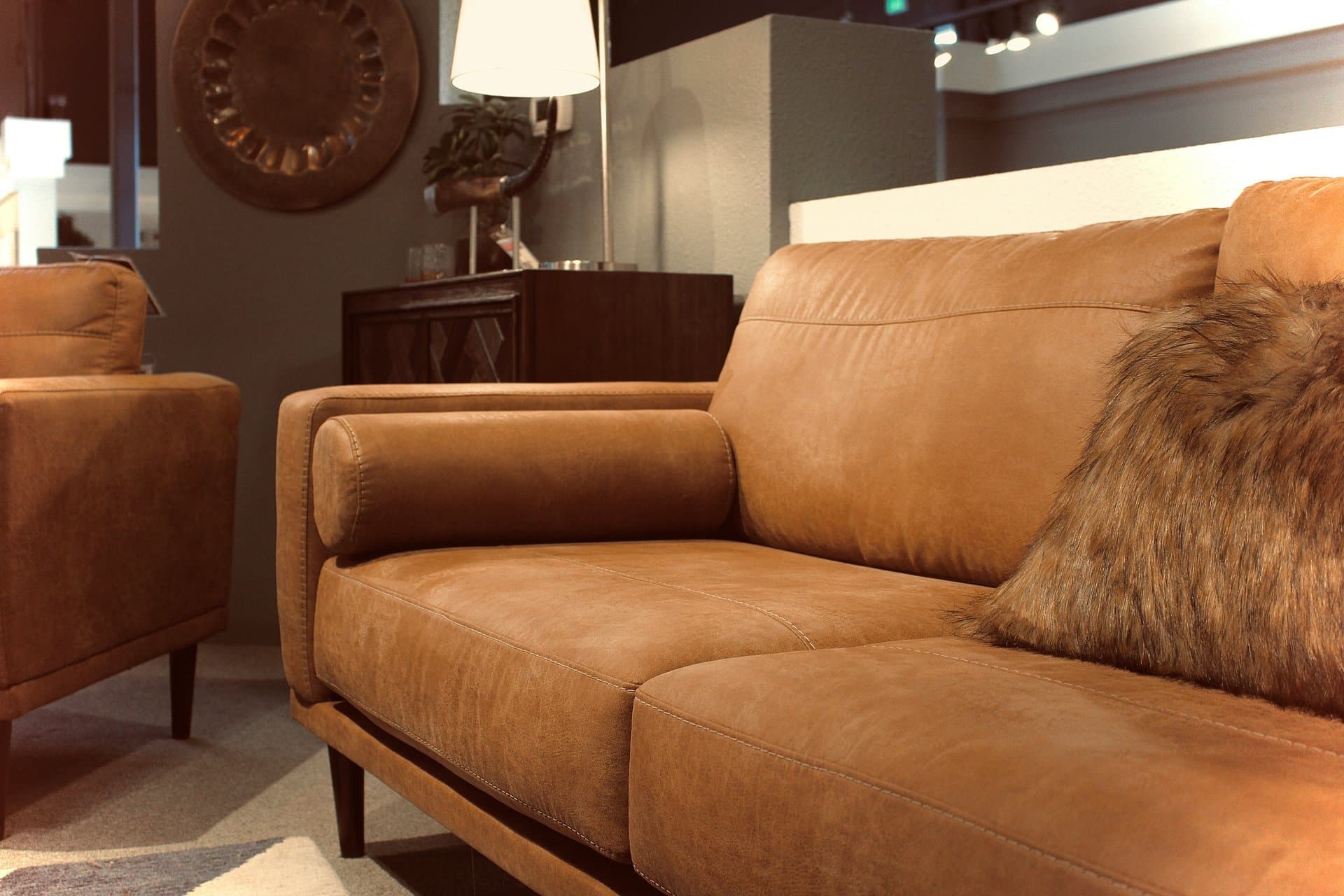 brown sofa with fur cushions