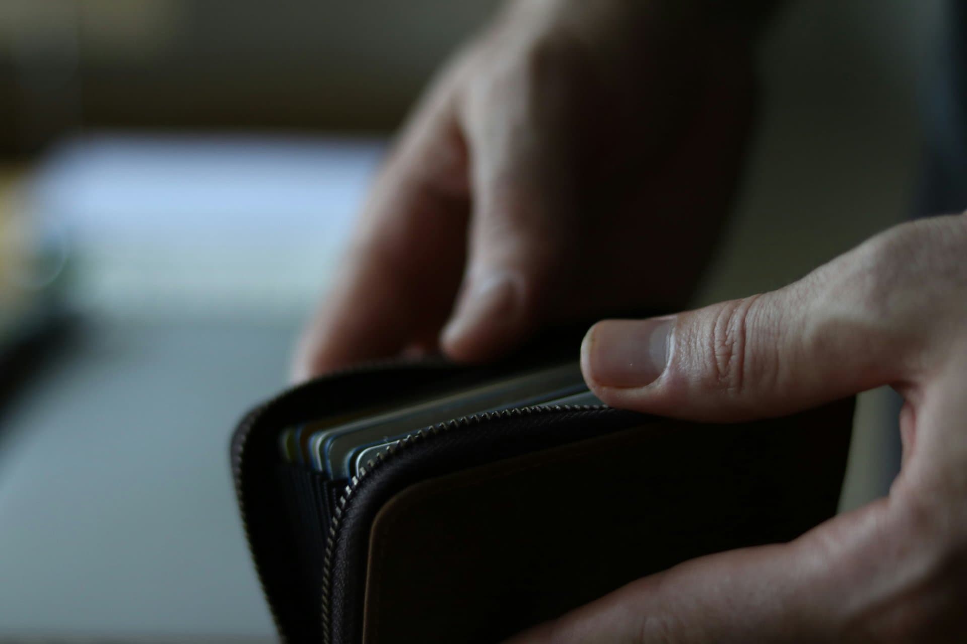 a hand holding a card wallet