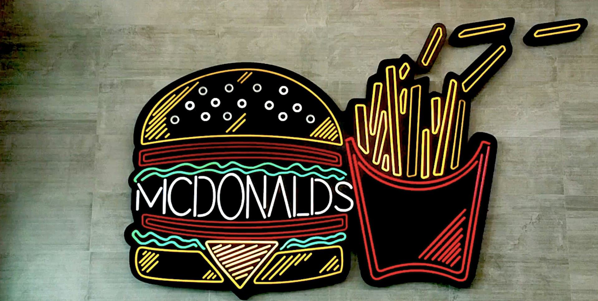 a neon light of a fast food chain