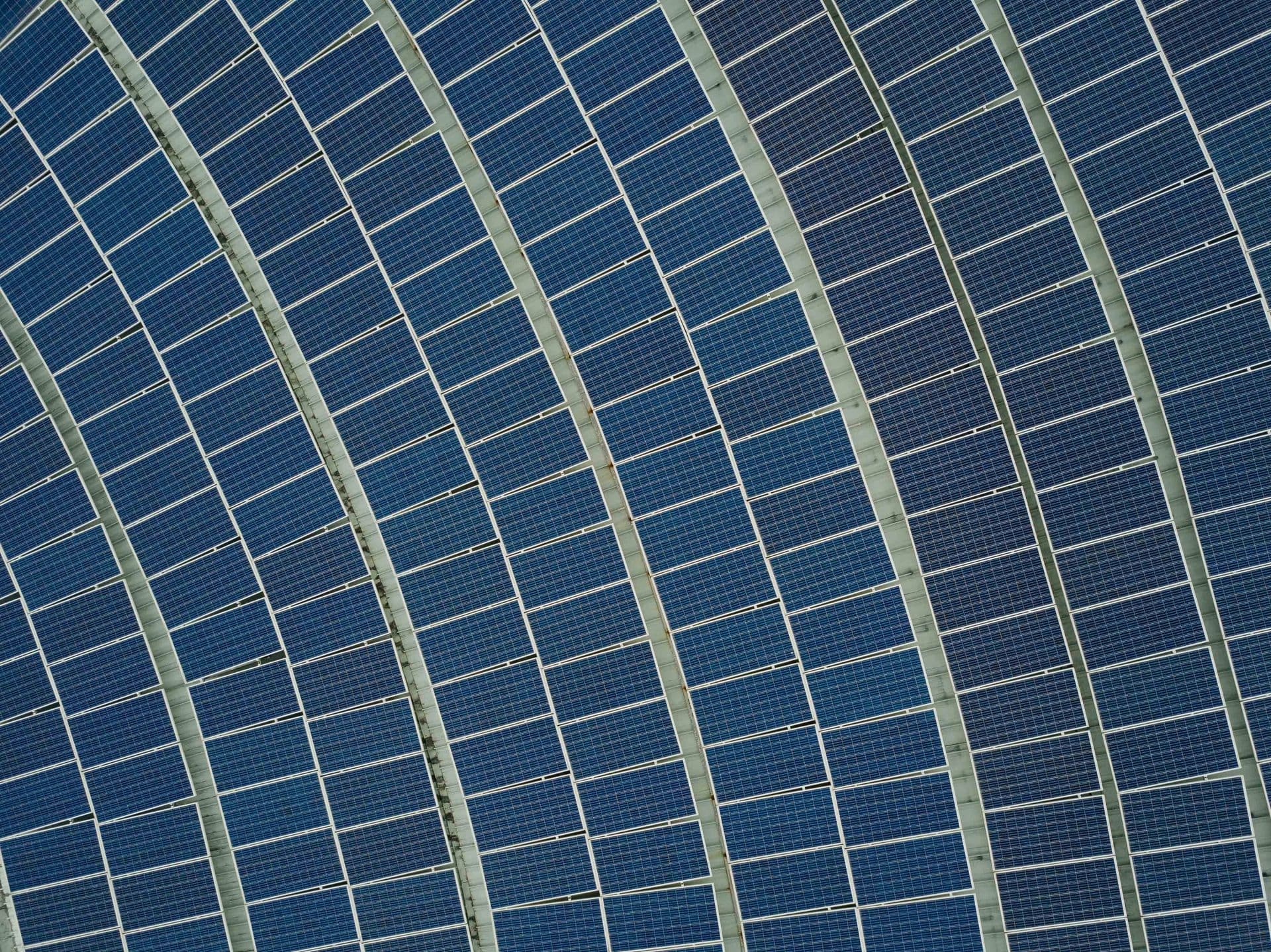 an ariel view of solar panels in a field