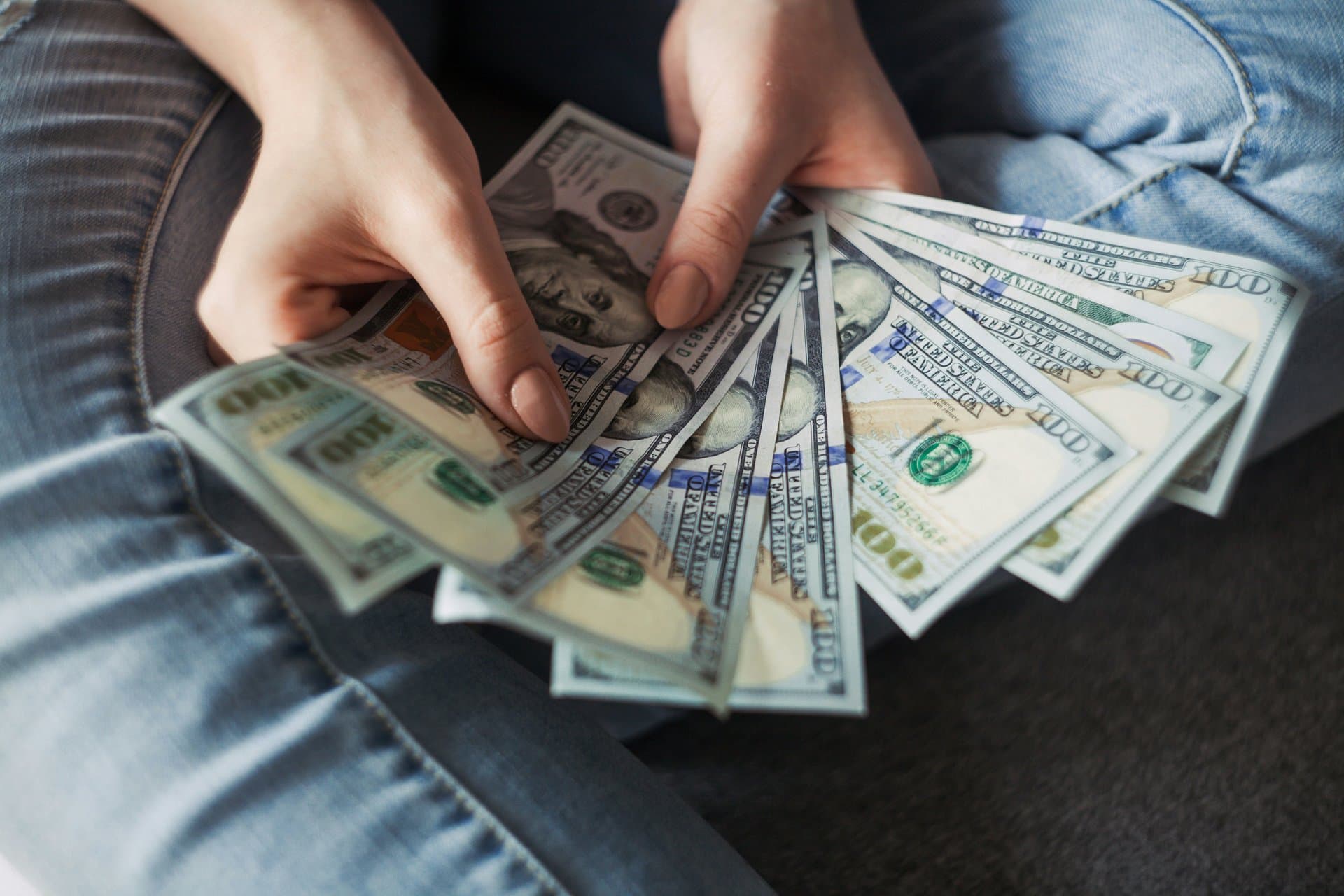 a person holding dollar bills