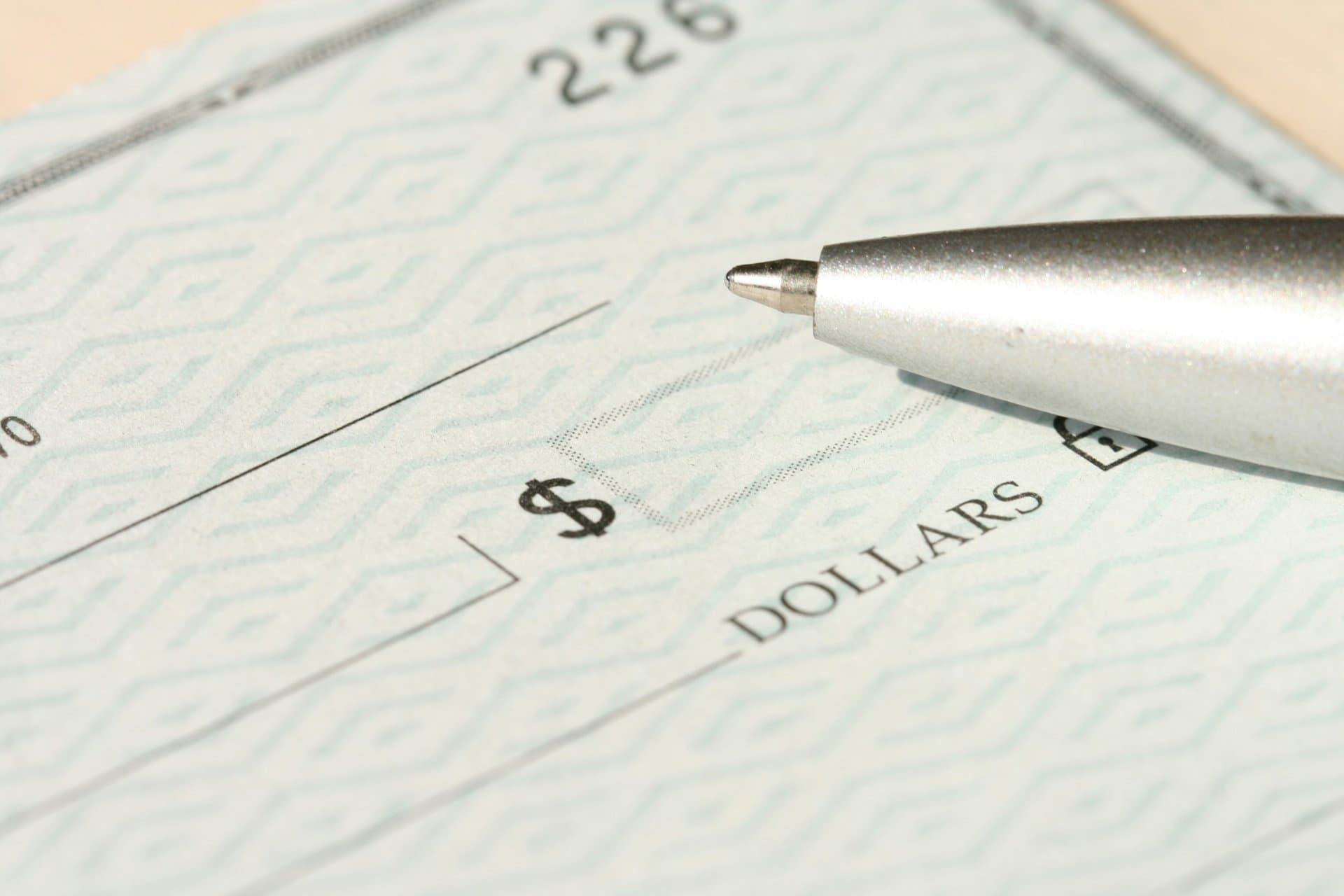 an empty cheque and a pen
