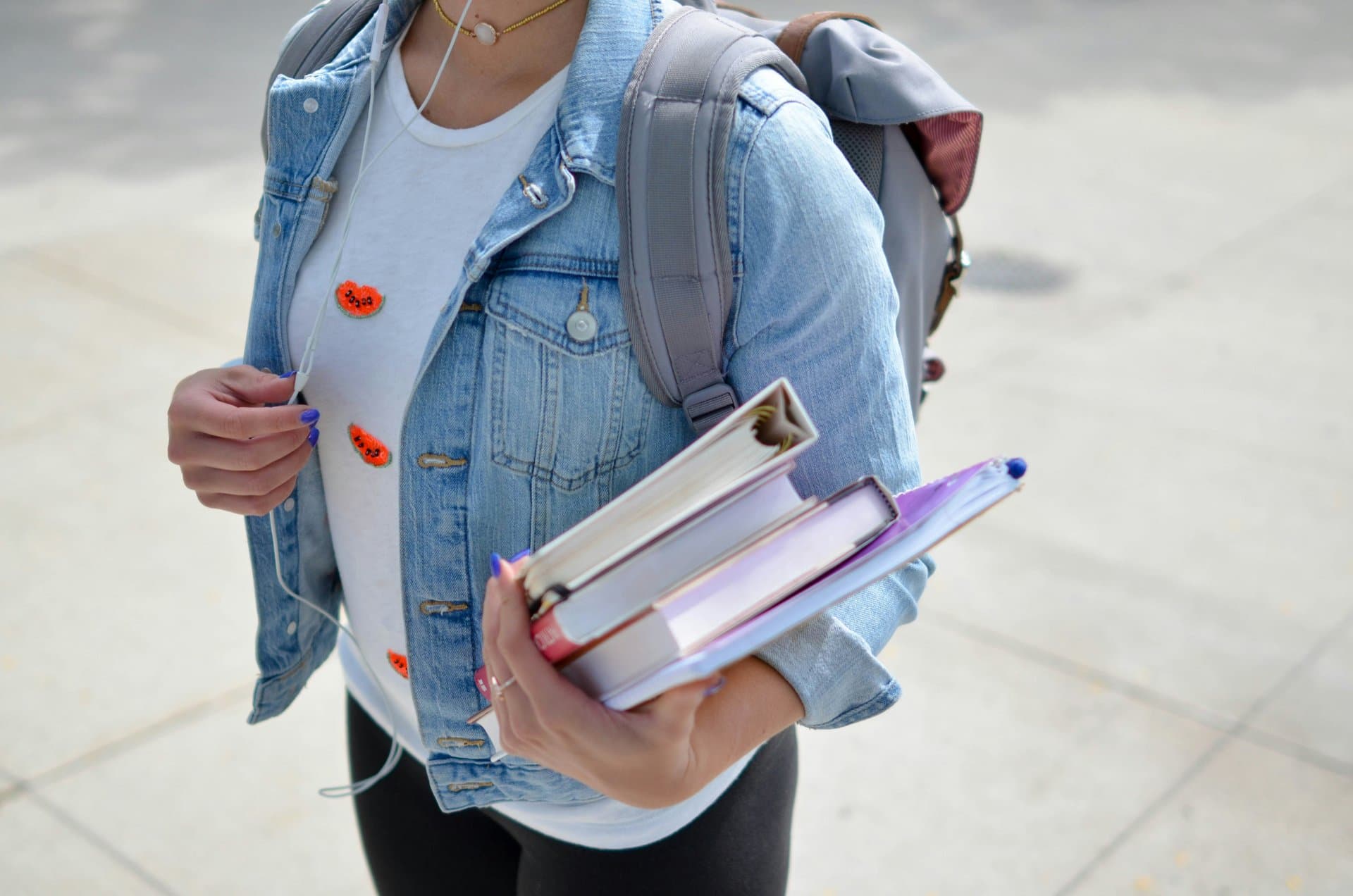 a student holding books in her arms