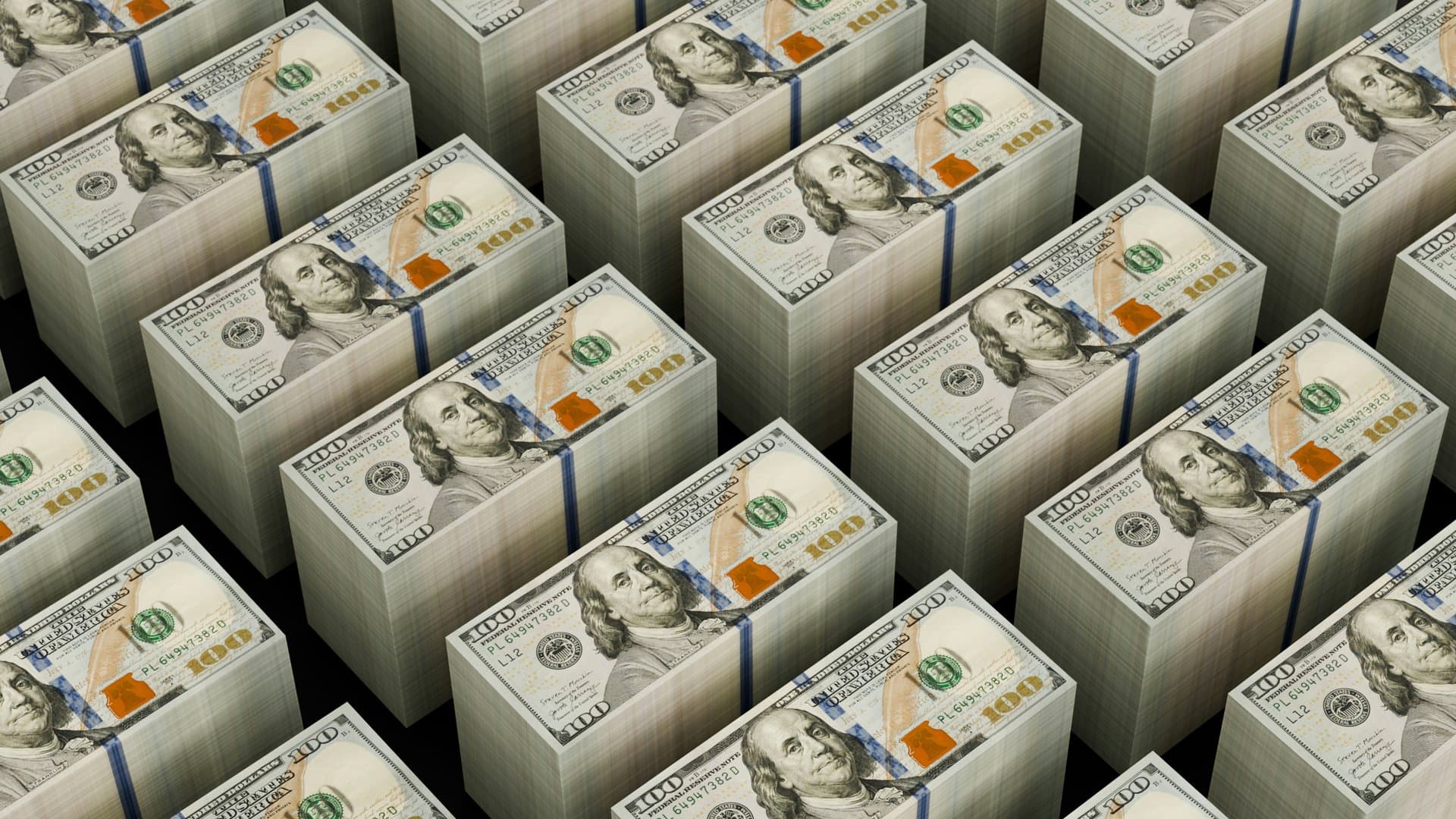 piles of dollarbills lined up