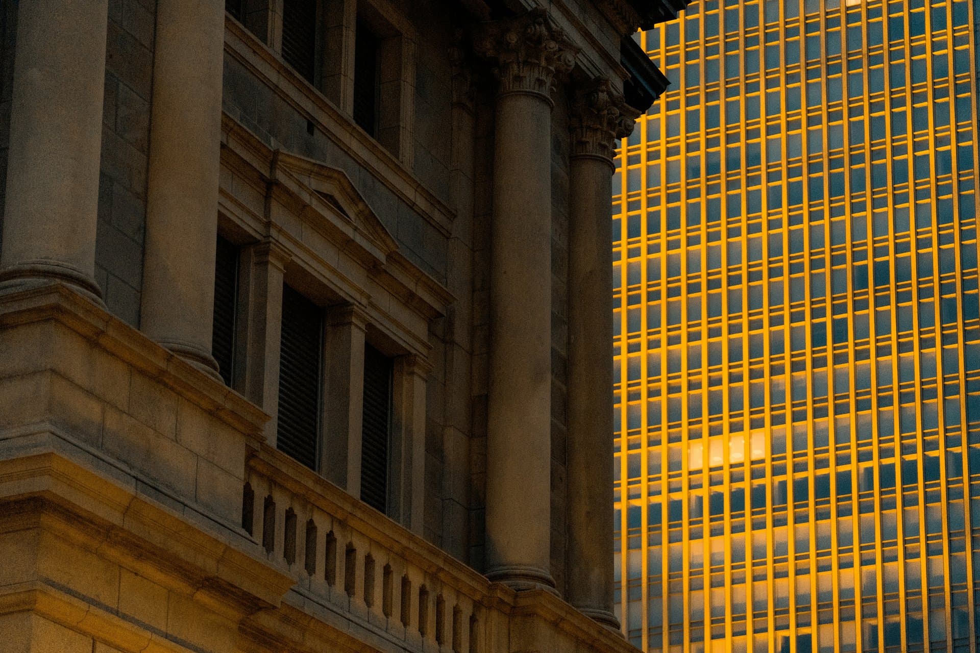2 tall buildings reflecting sunlight