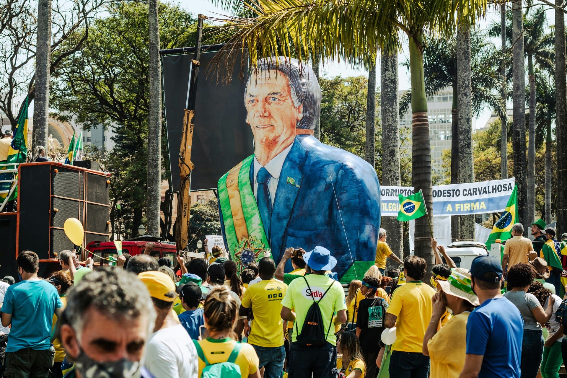 a parade with bolsonaro balloon