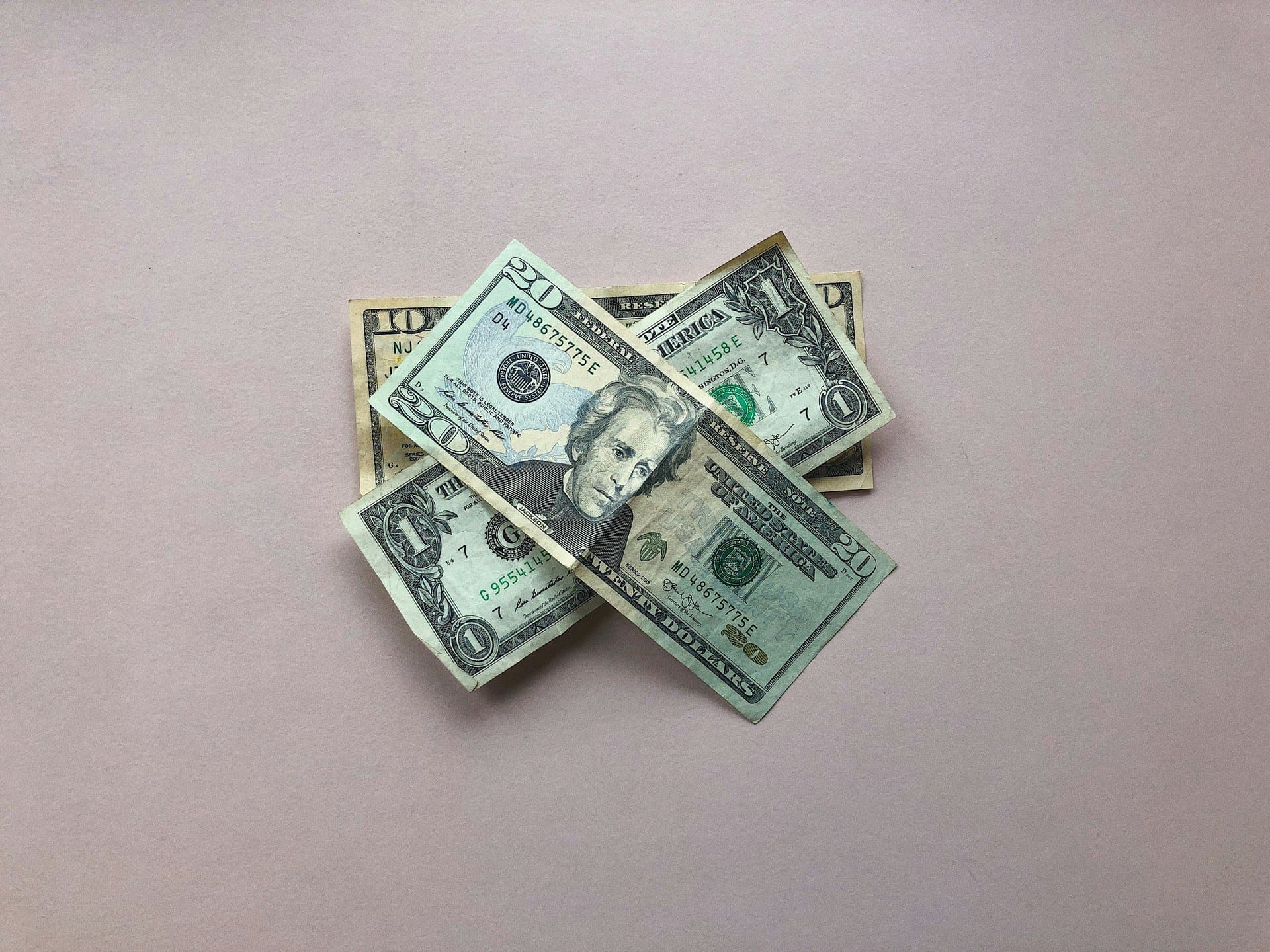 3 dollar bills on a table