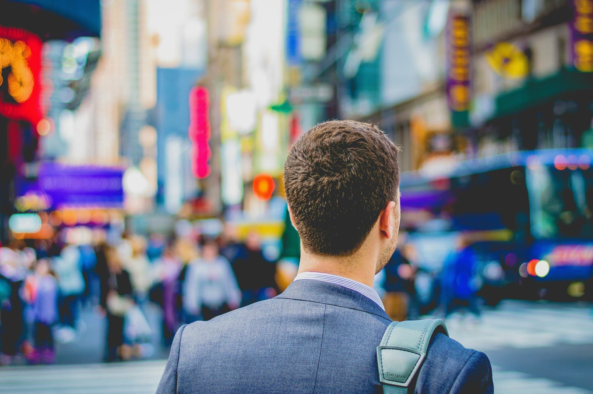 back of a man's head looking at times square