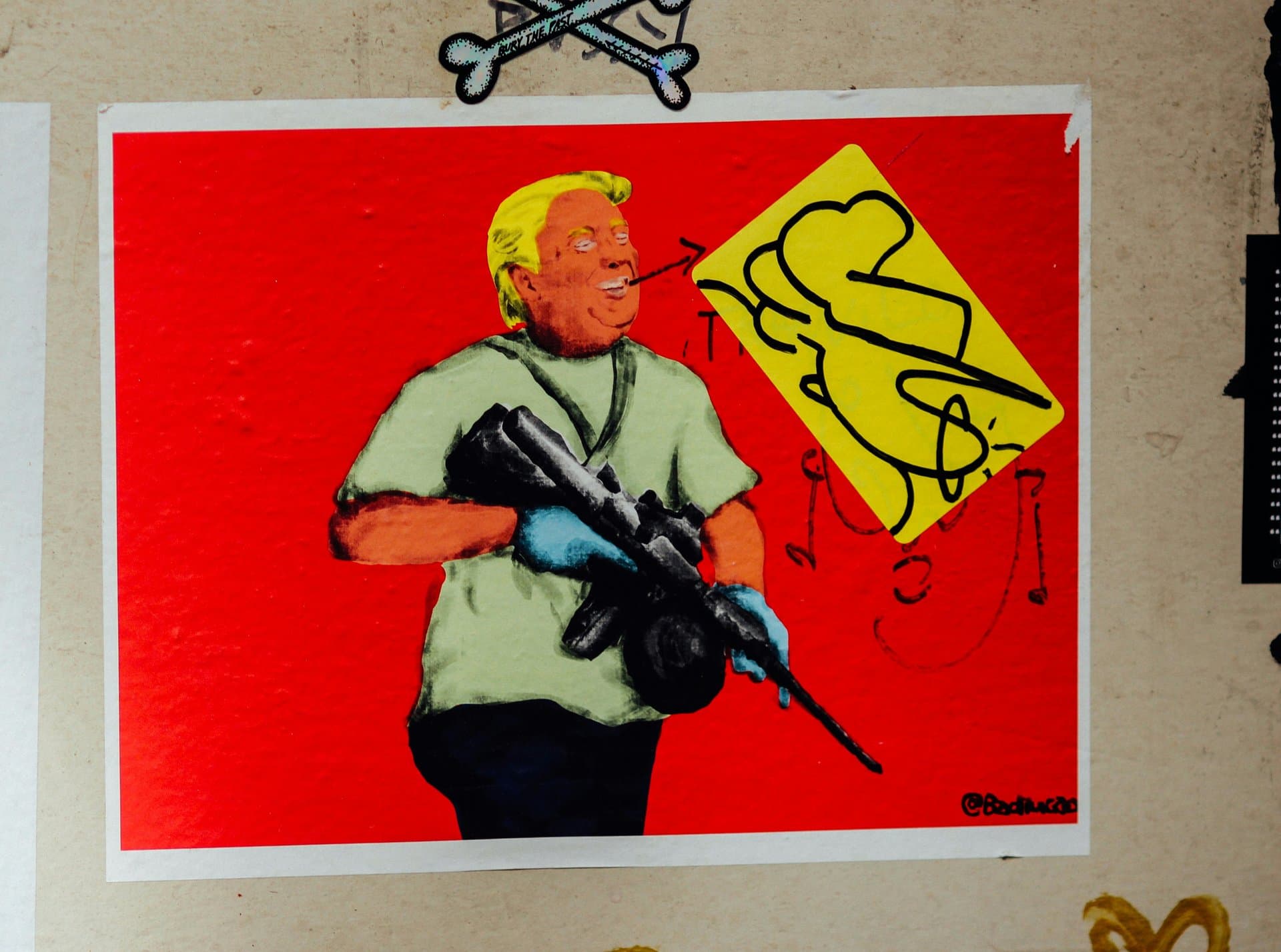 a mural of a man with yellow hair holding a gun
