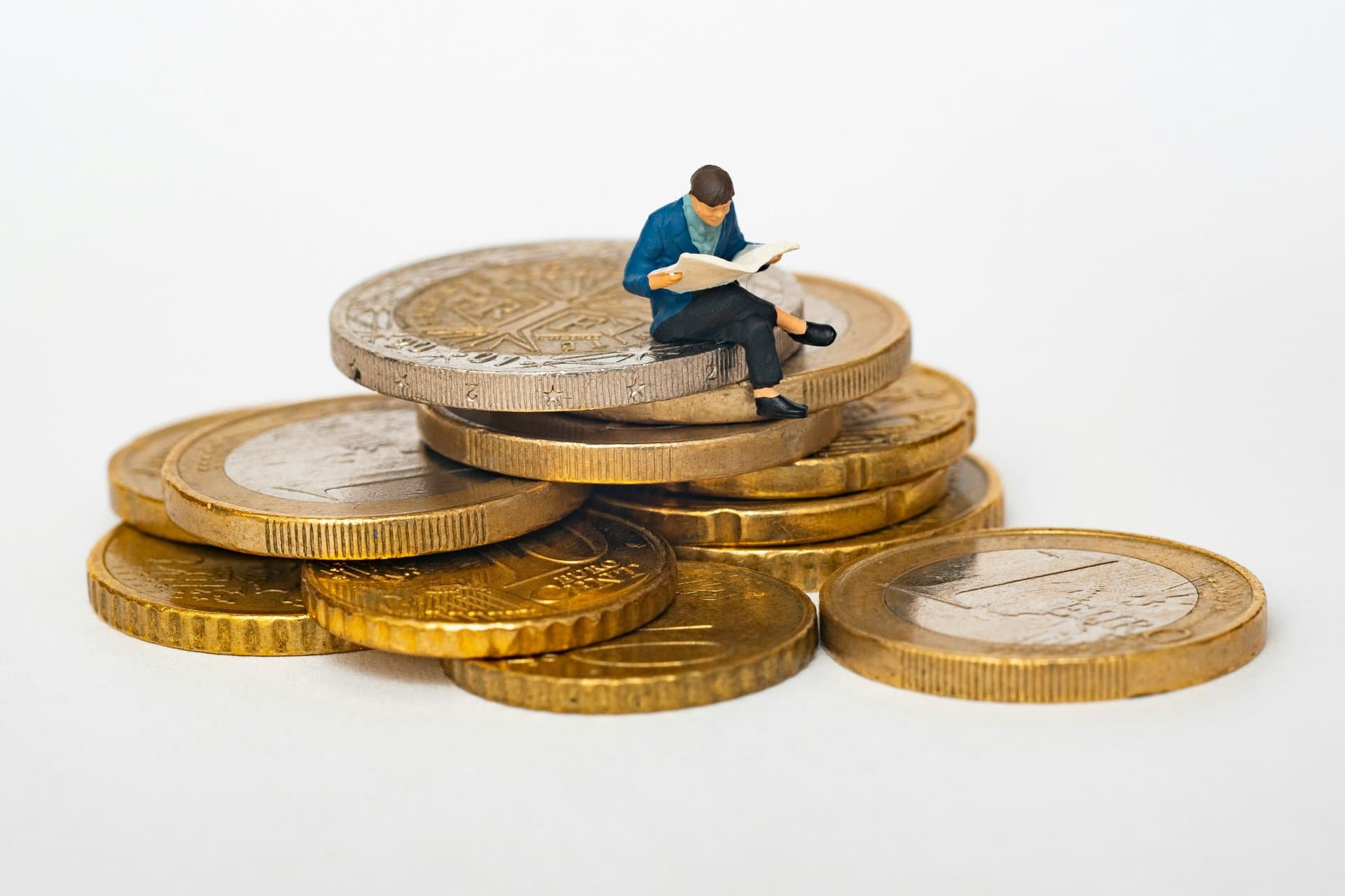 a human caricature sitting on coins