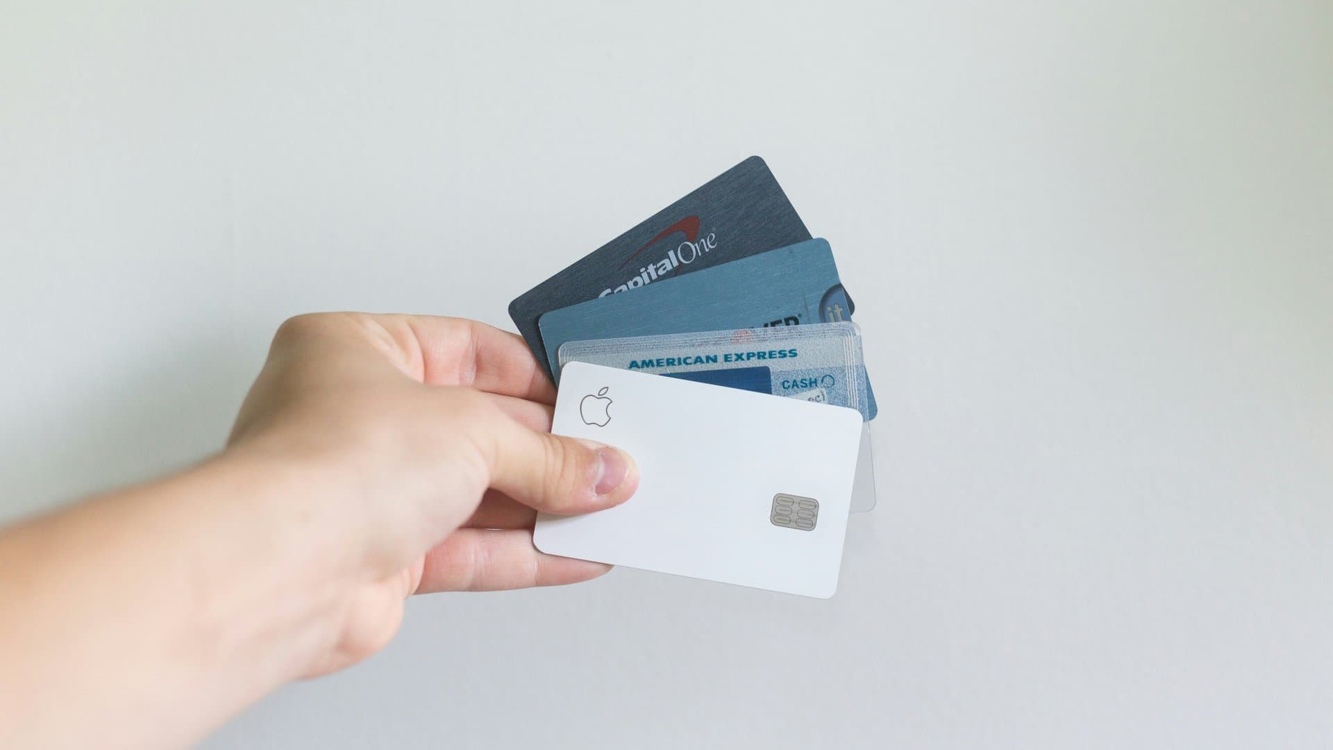 a hand holding multiple credit cards