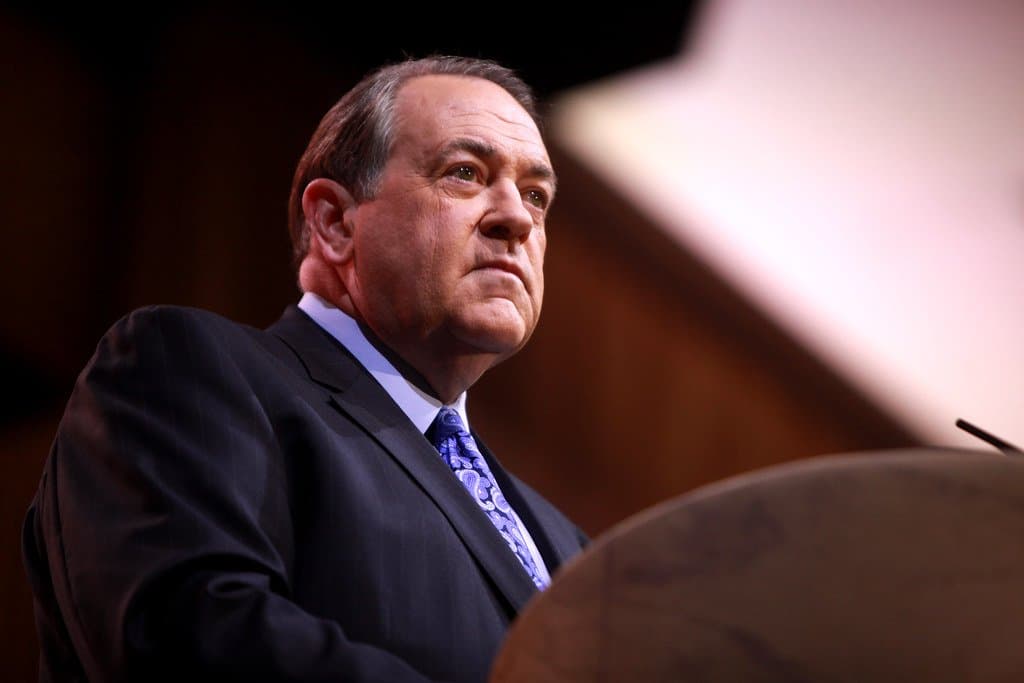 a picture of an old man speaking from a podium