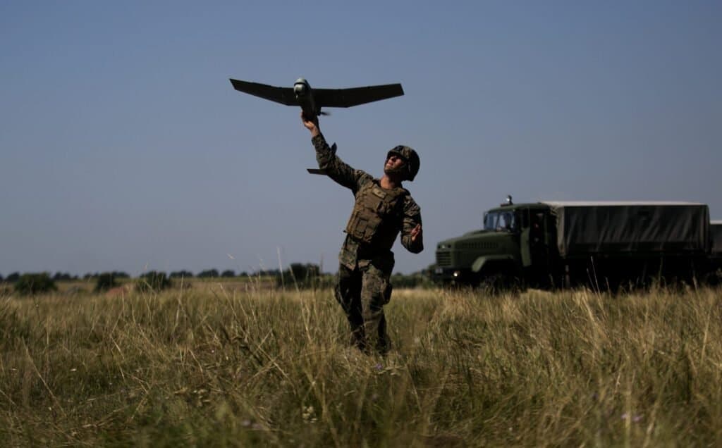 a soldier throwing a drone in the air