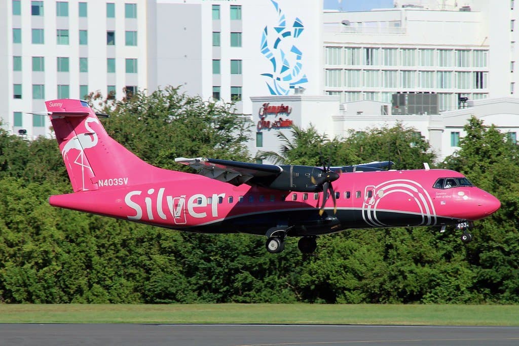 a pink airplane landing