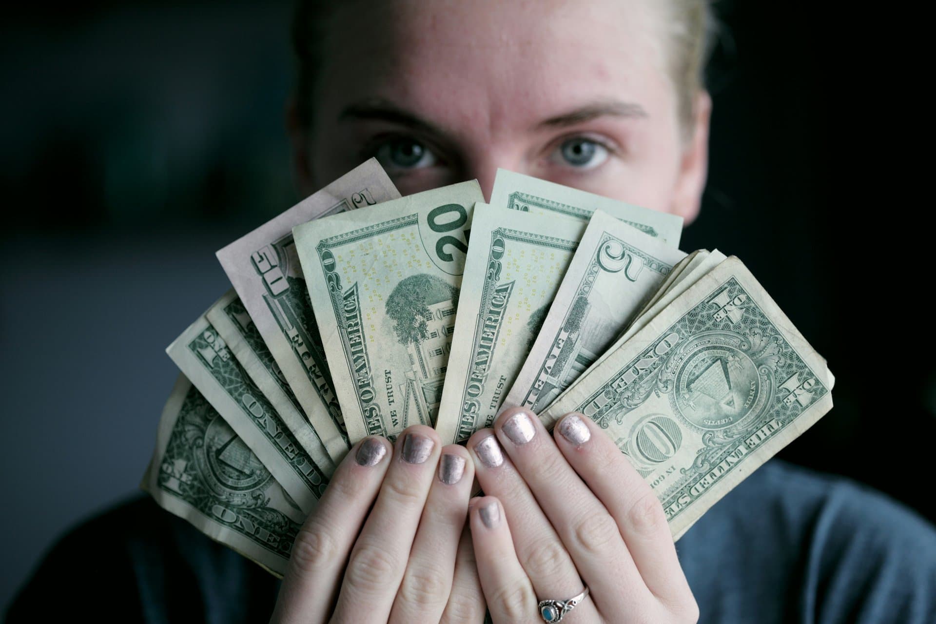 a person holding dollar bills