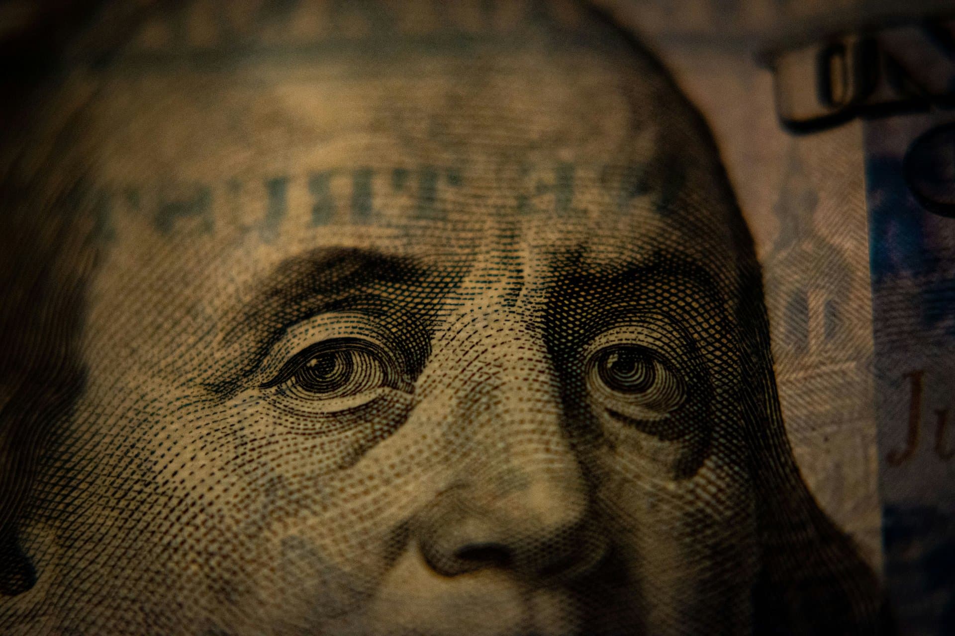 a zoom in on the face on dollar bill