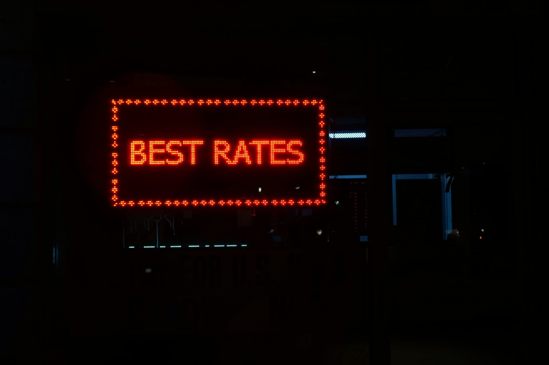 a neon sign saying Best Rates