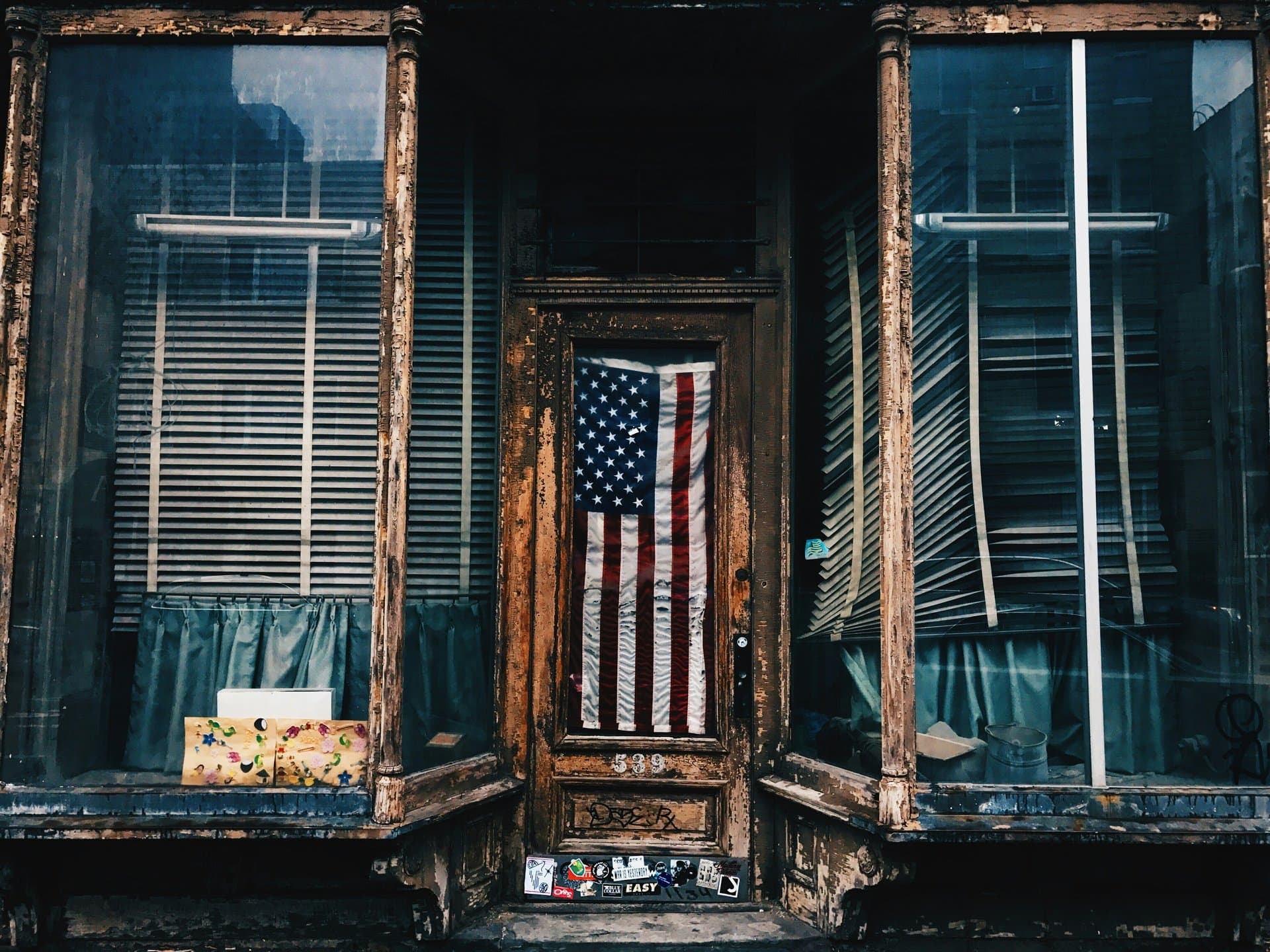 a worne out shop with american flag