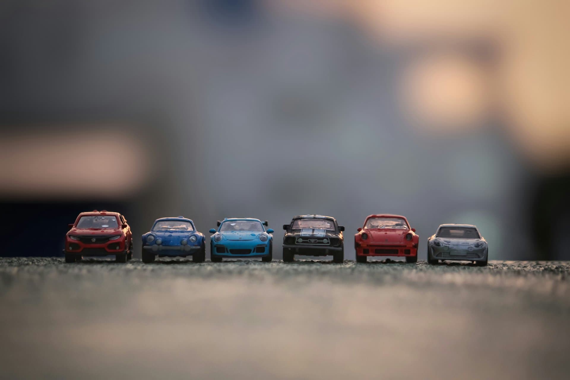 a series of toy cars lined up