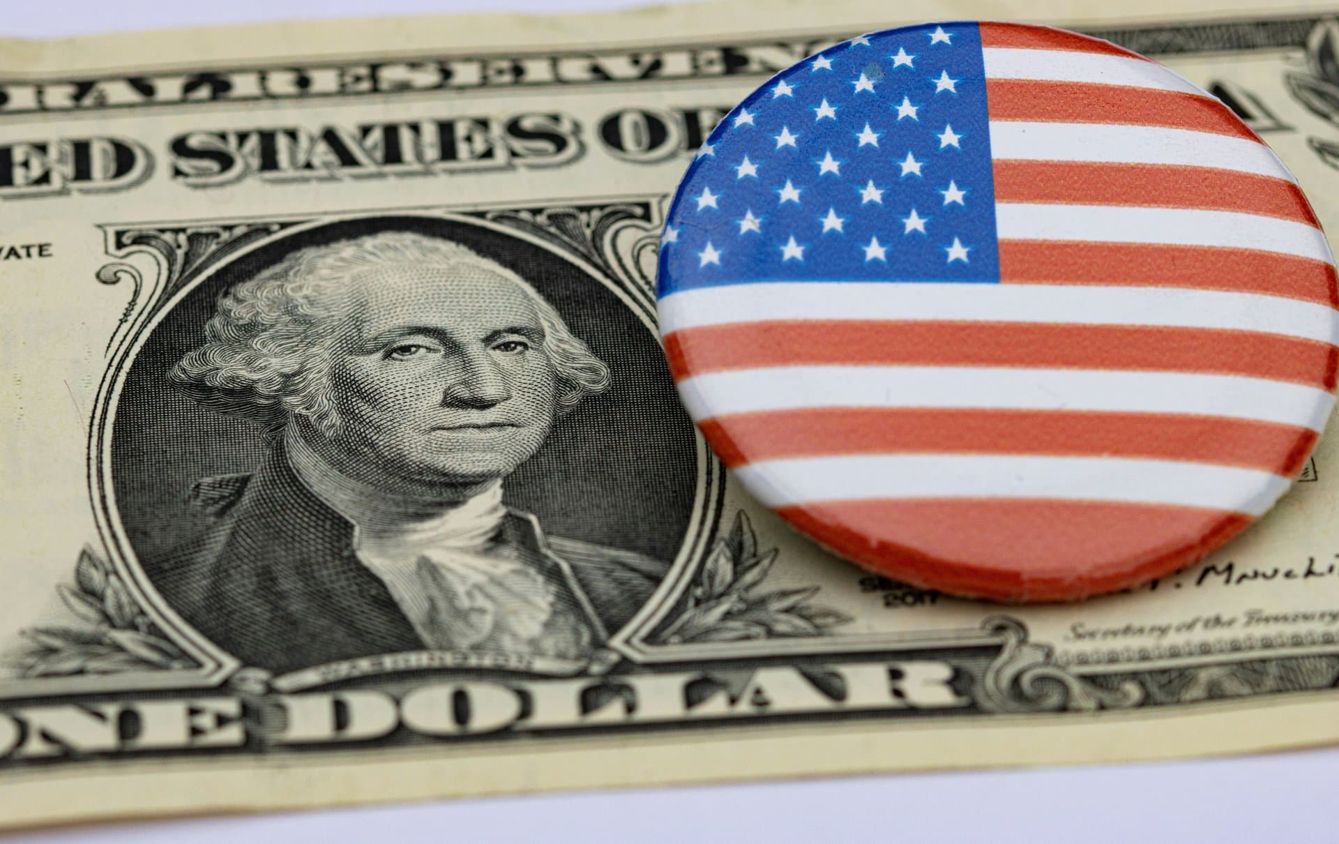 a dollar with a badge of an american flag on it