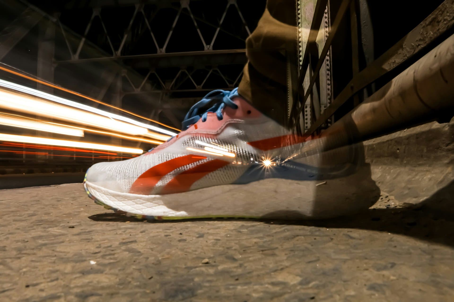 a colorful shoe with lights in background