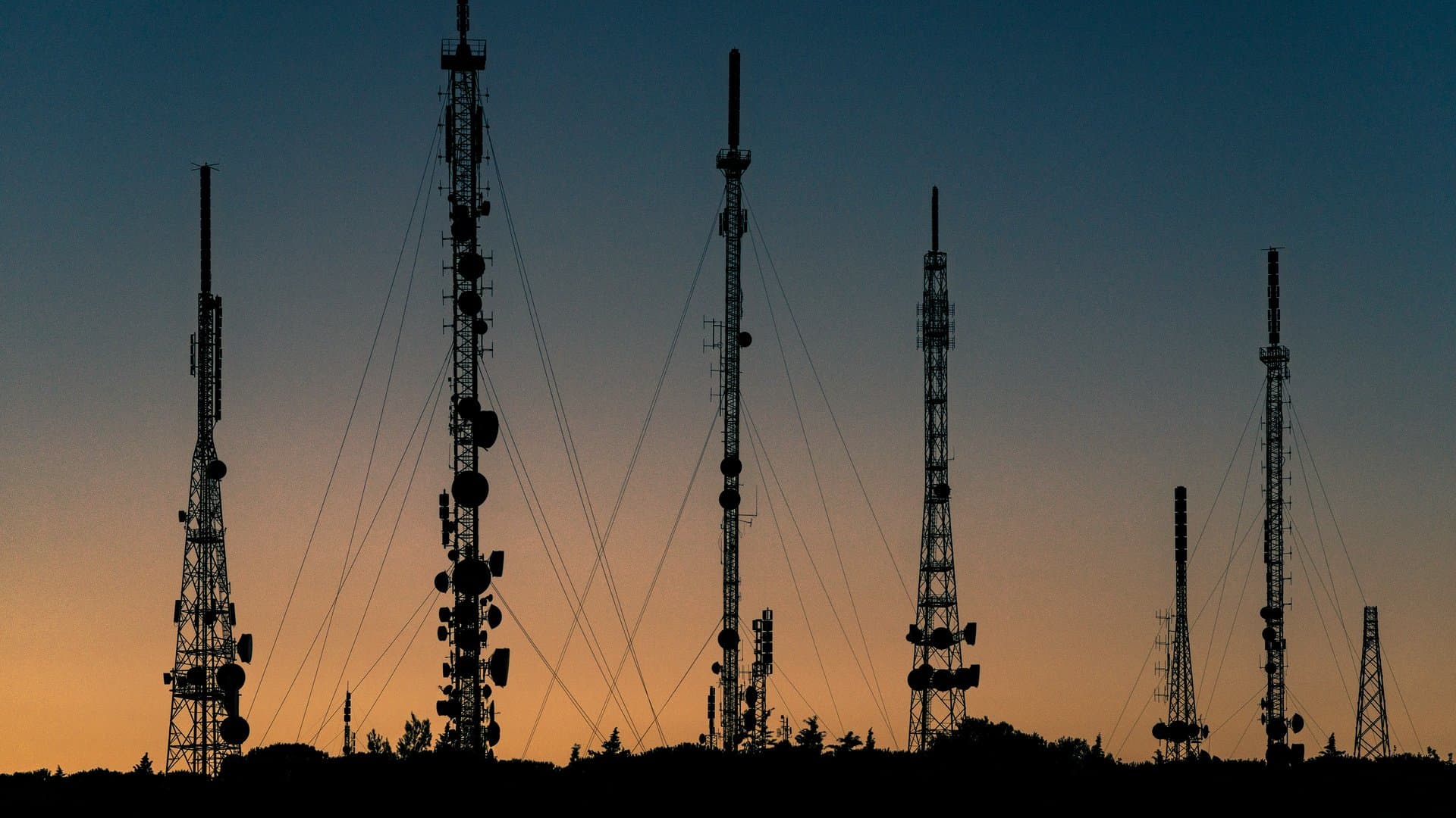 telecom towers at sunset