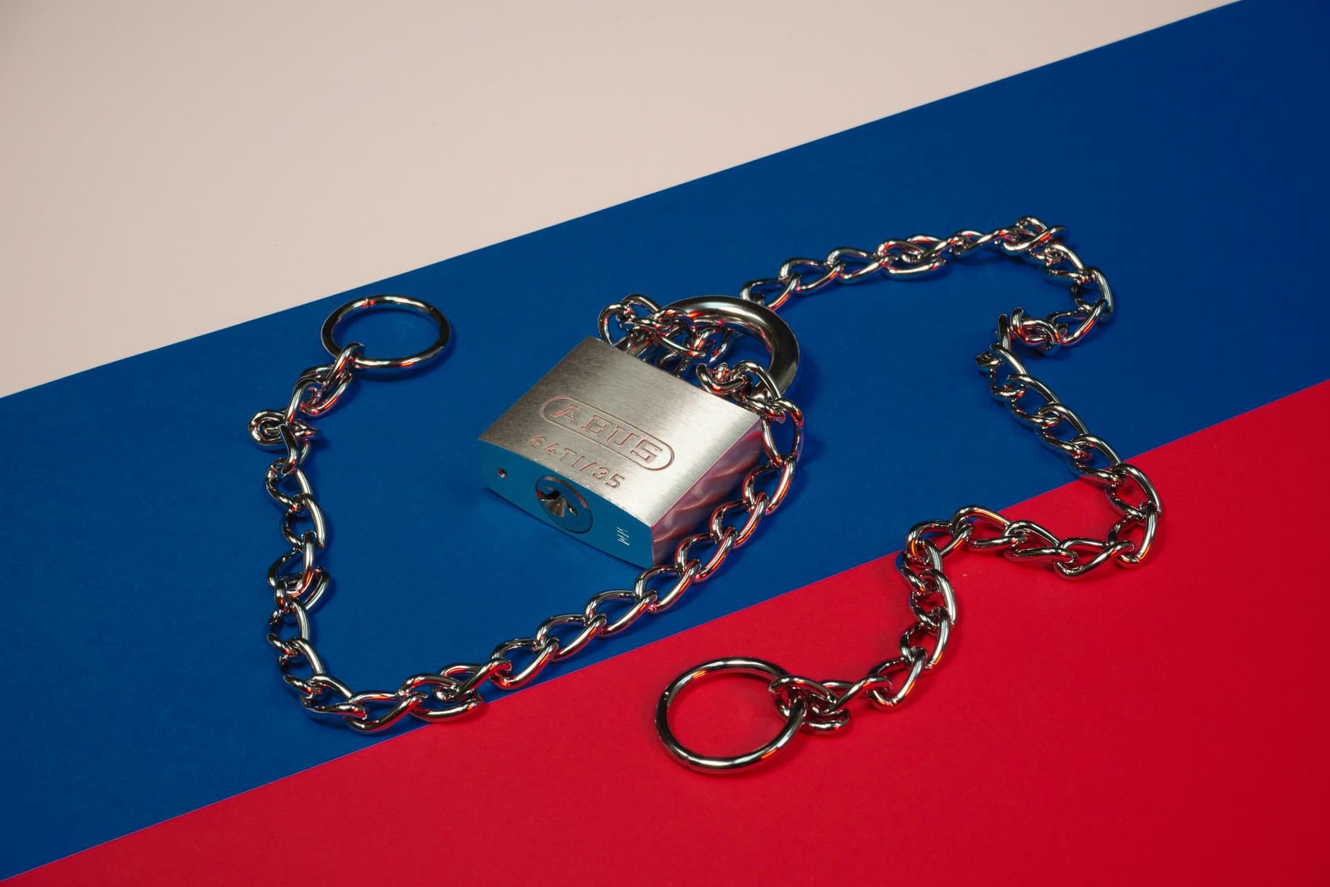 lock and chains over the russian flag