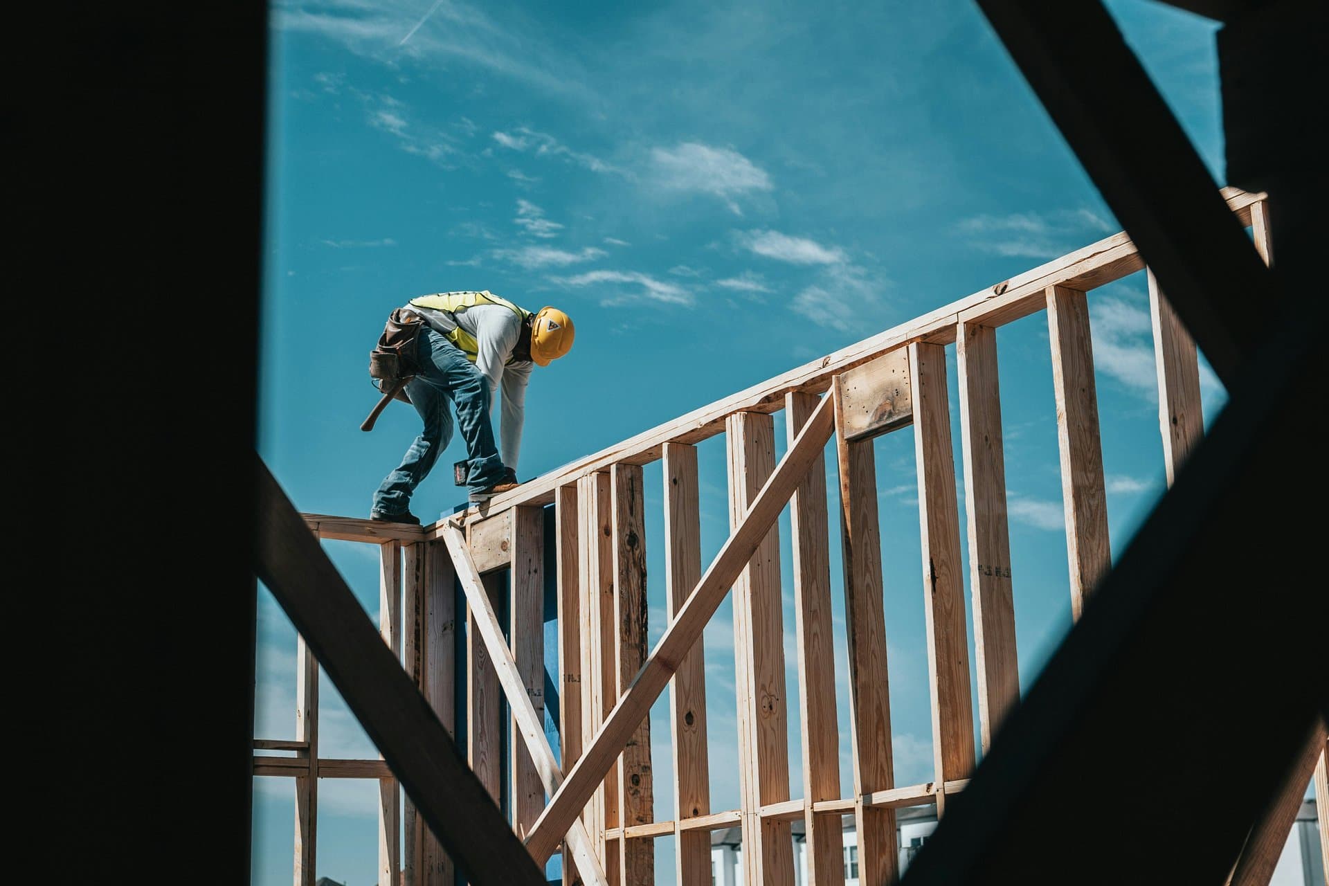 a construction worker on top of a wip house
