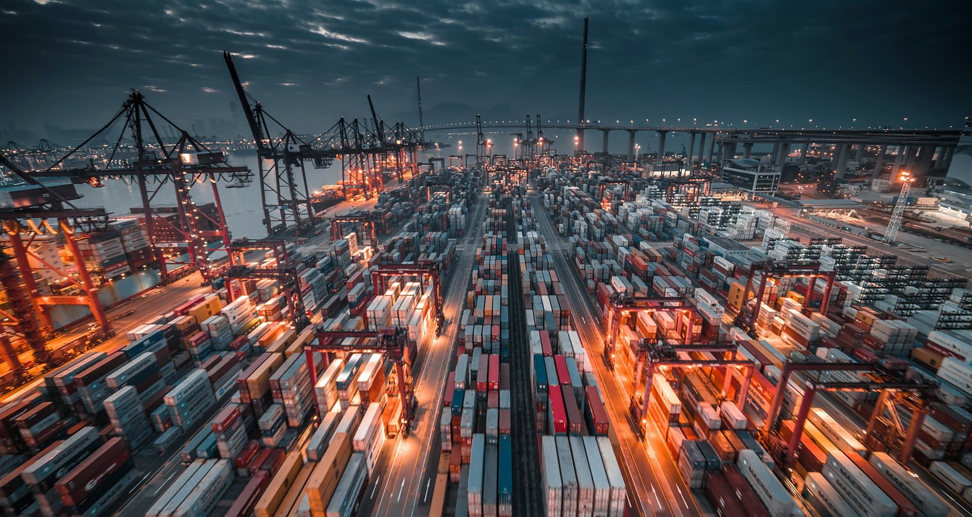 Ships and fleet of cargos on a dock at night.