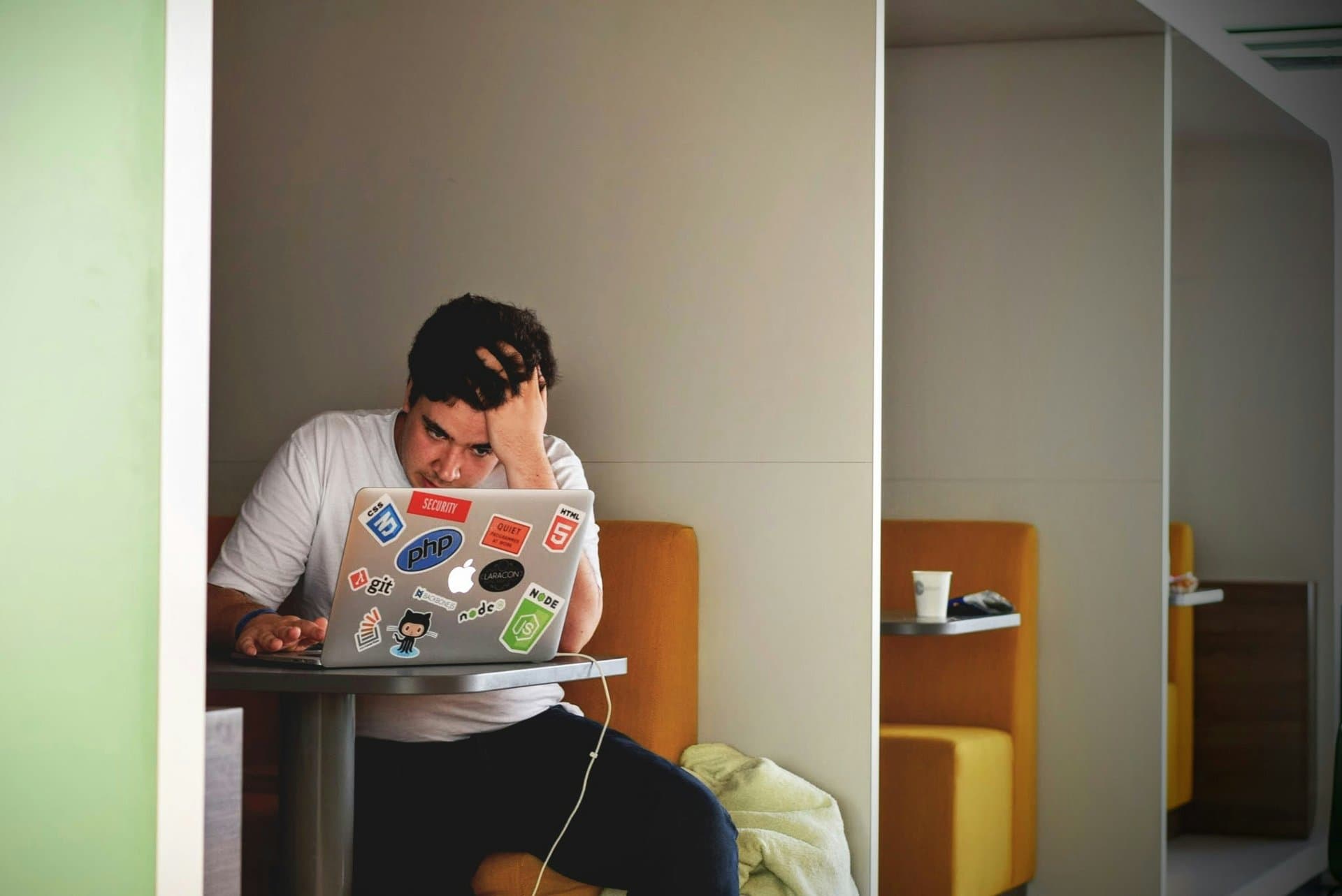 A young man looking in his laptop stressed