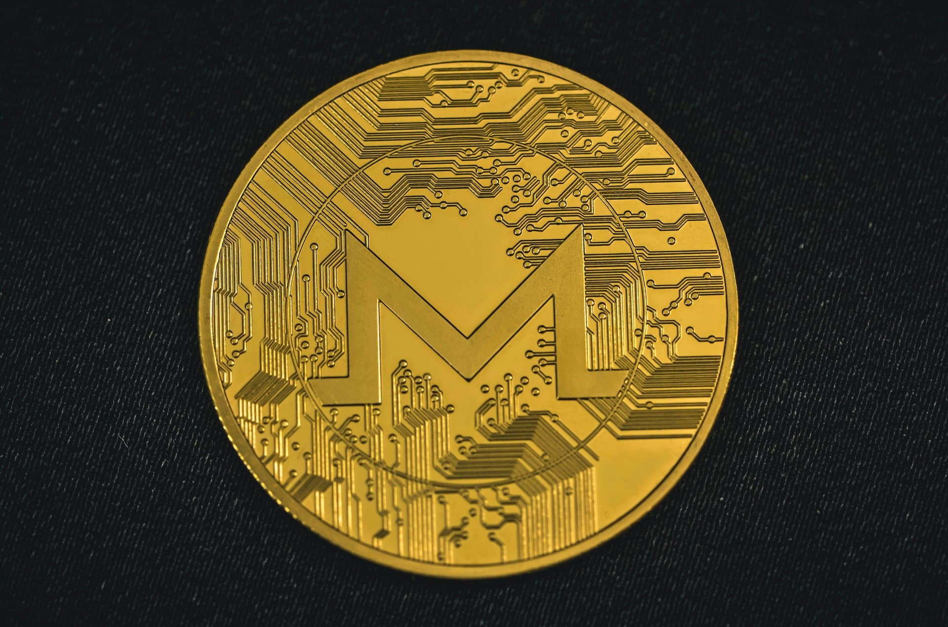 a gold coin with monero logo
