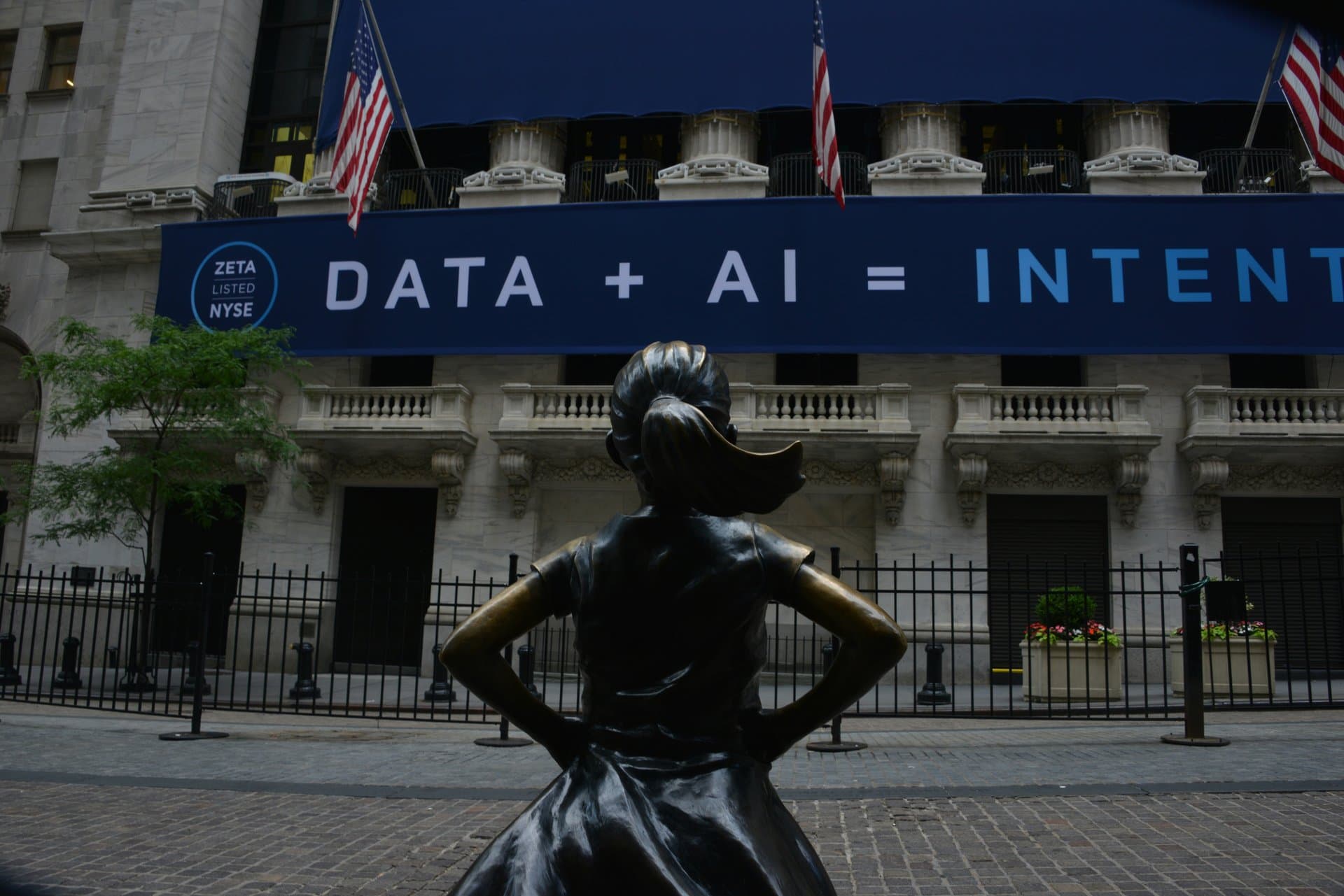 a girl statue looking at a banner