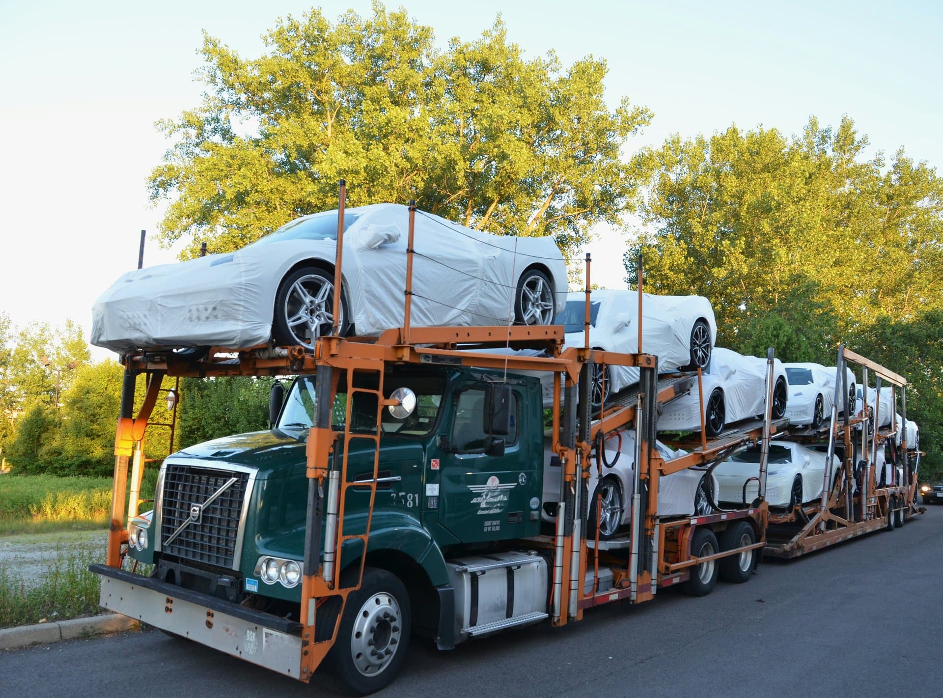 a trailer carrying brand new cars