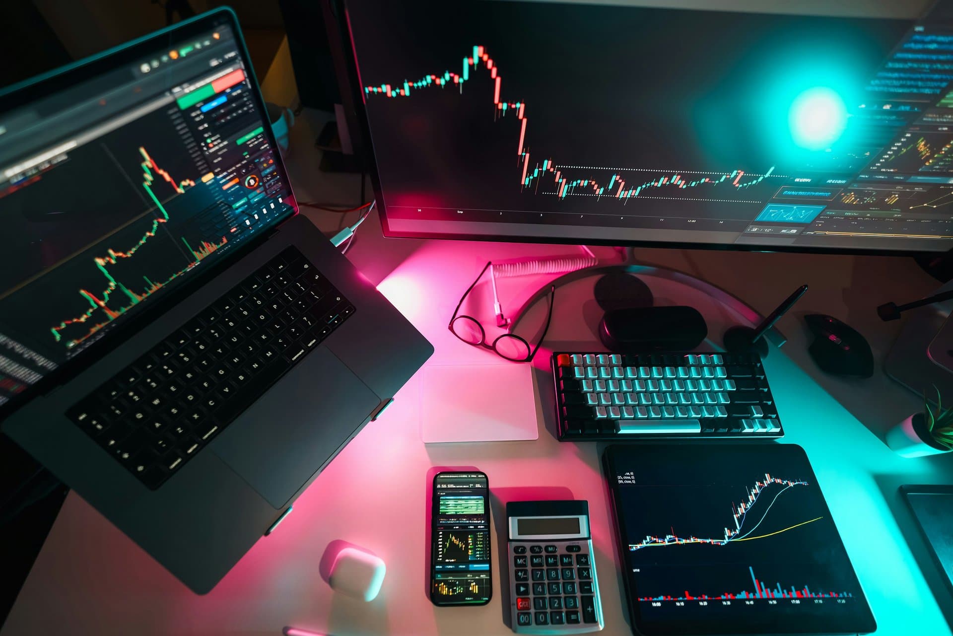 a desk with monitors and computers