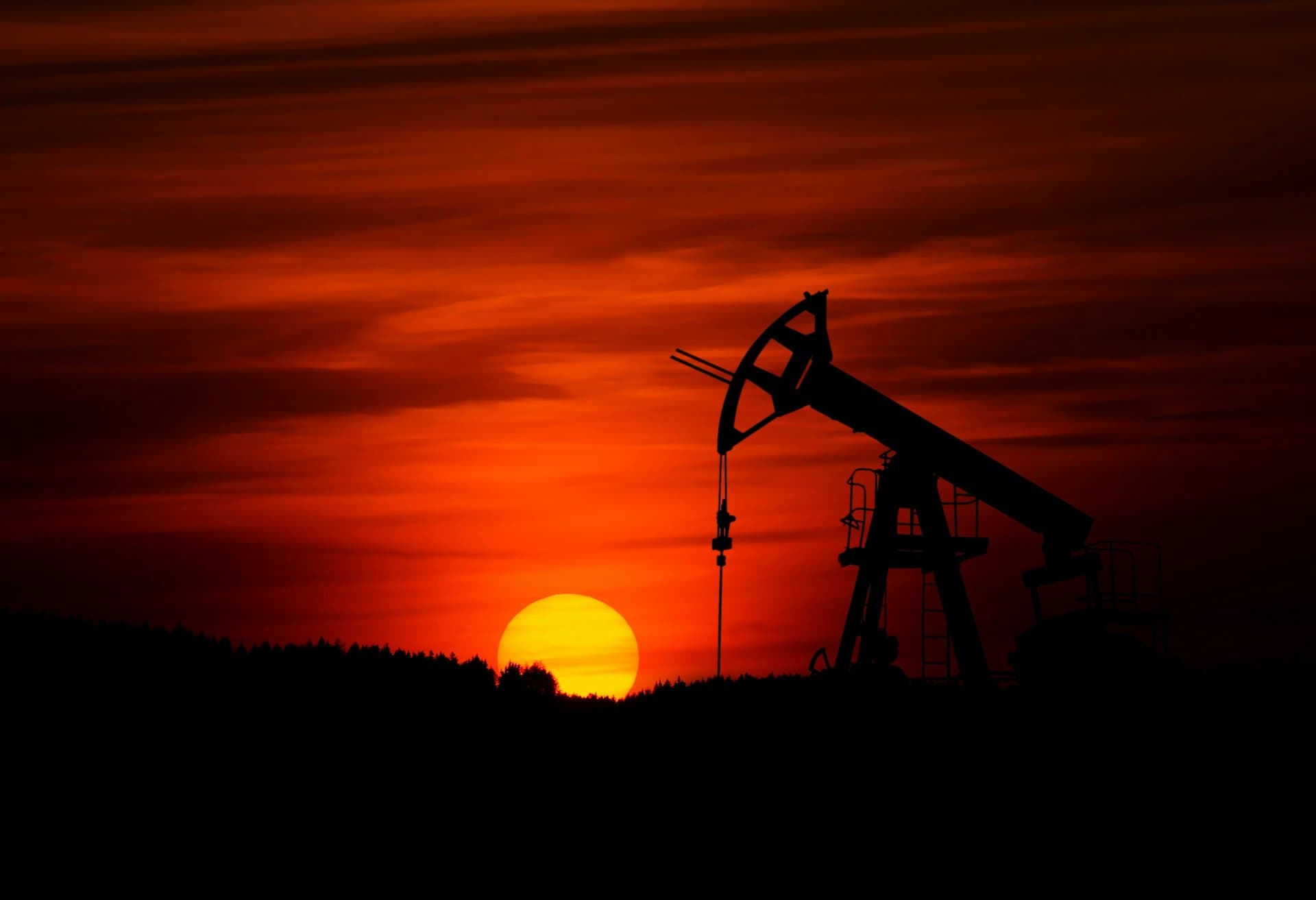 an oil drilling plant at sunset