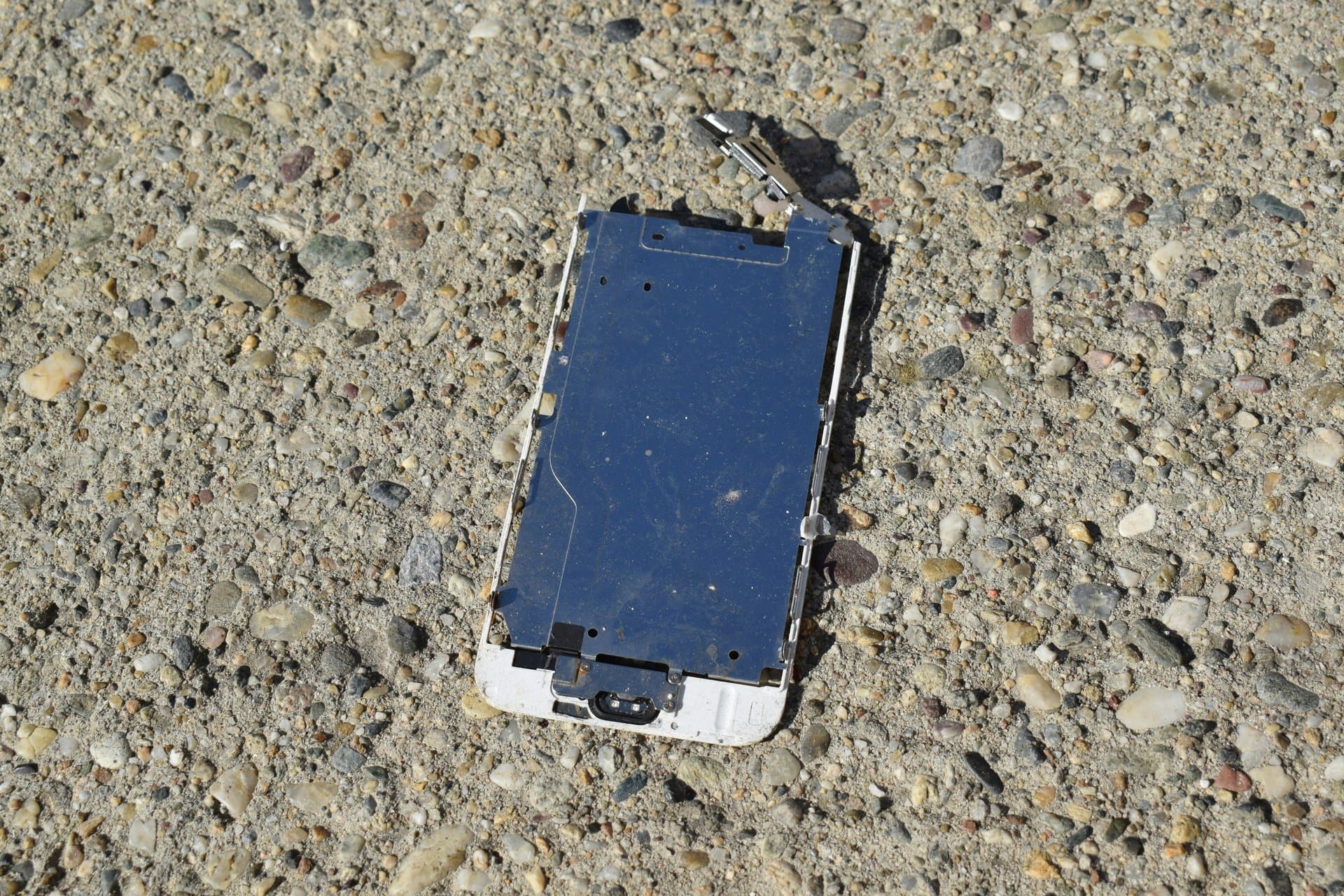 a broken smartphone on the road