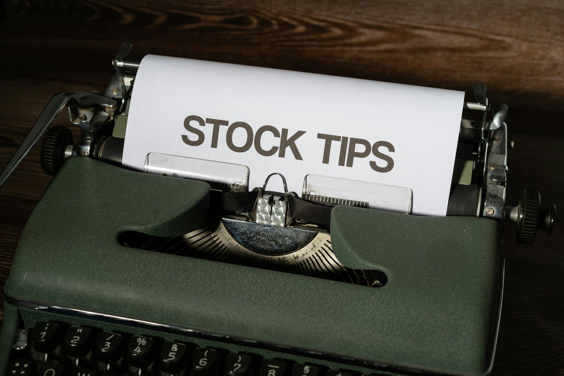 a typewriter with paper saying Stock Tips