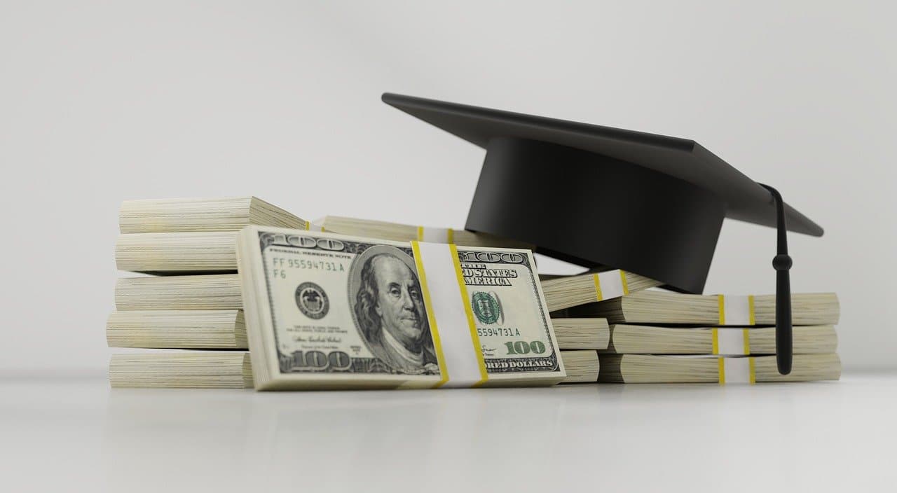 dollars and graduation hat