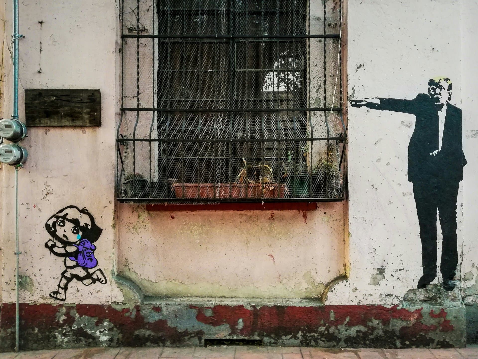 a wall with art mural of a man