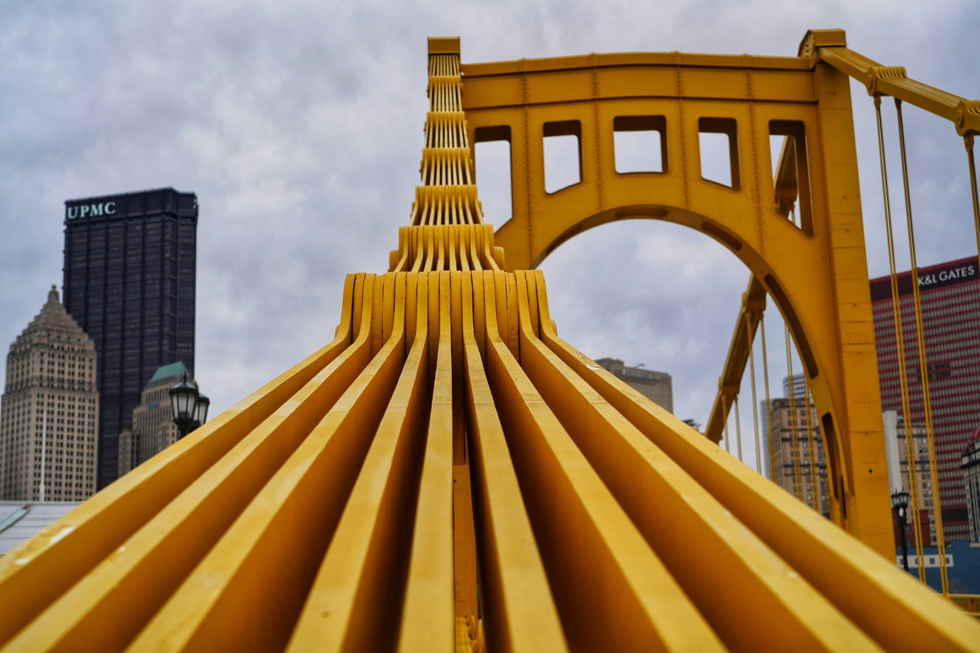a POV of a yellow metal bridge