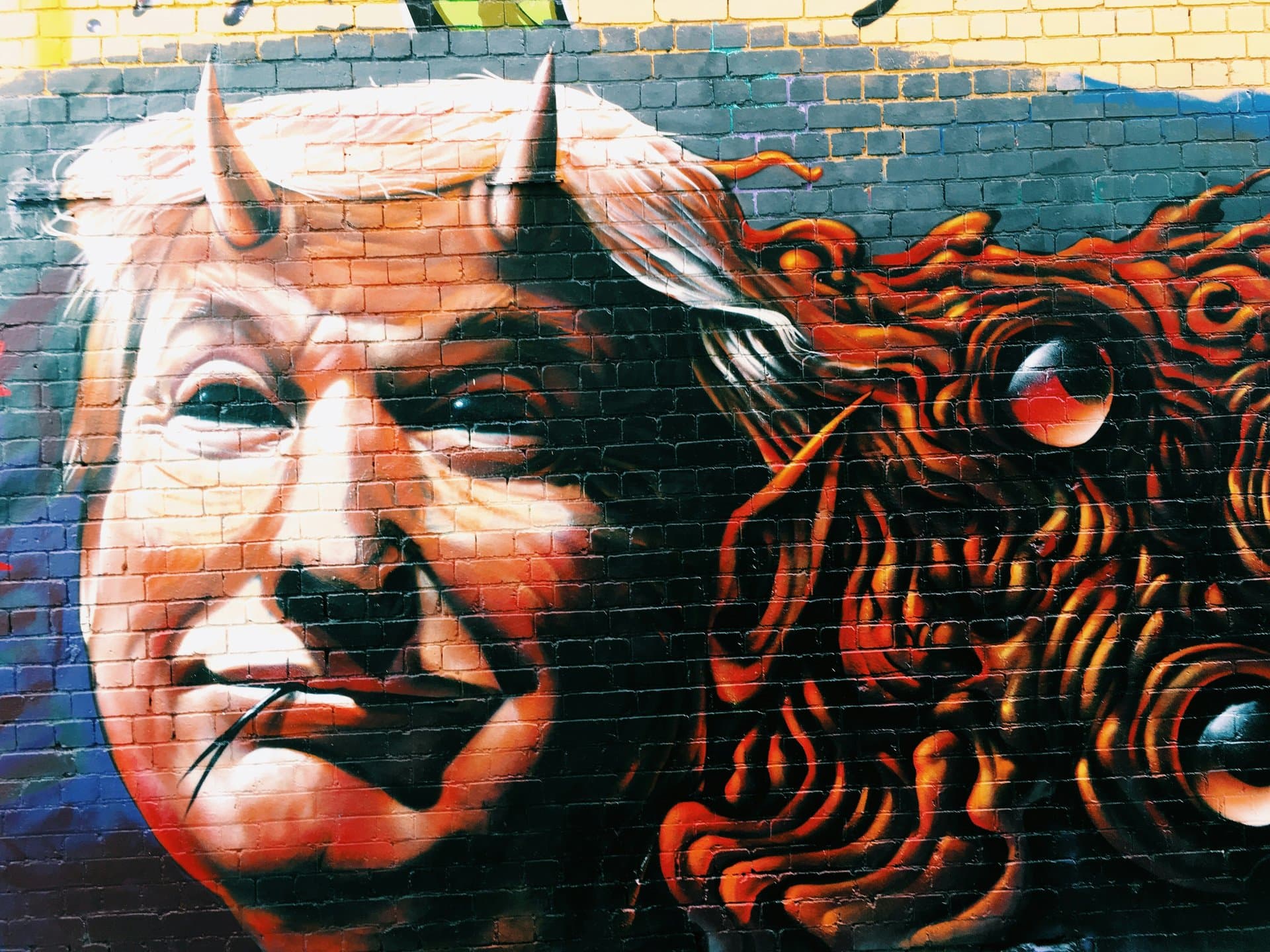 a grafitti of trump with horns