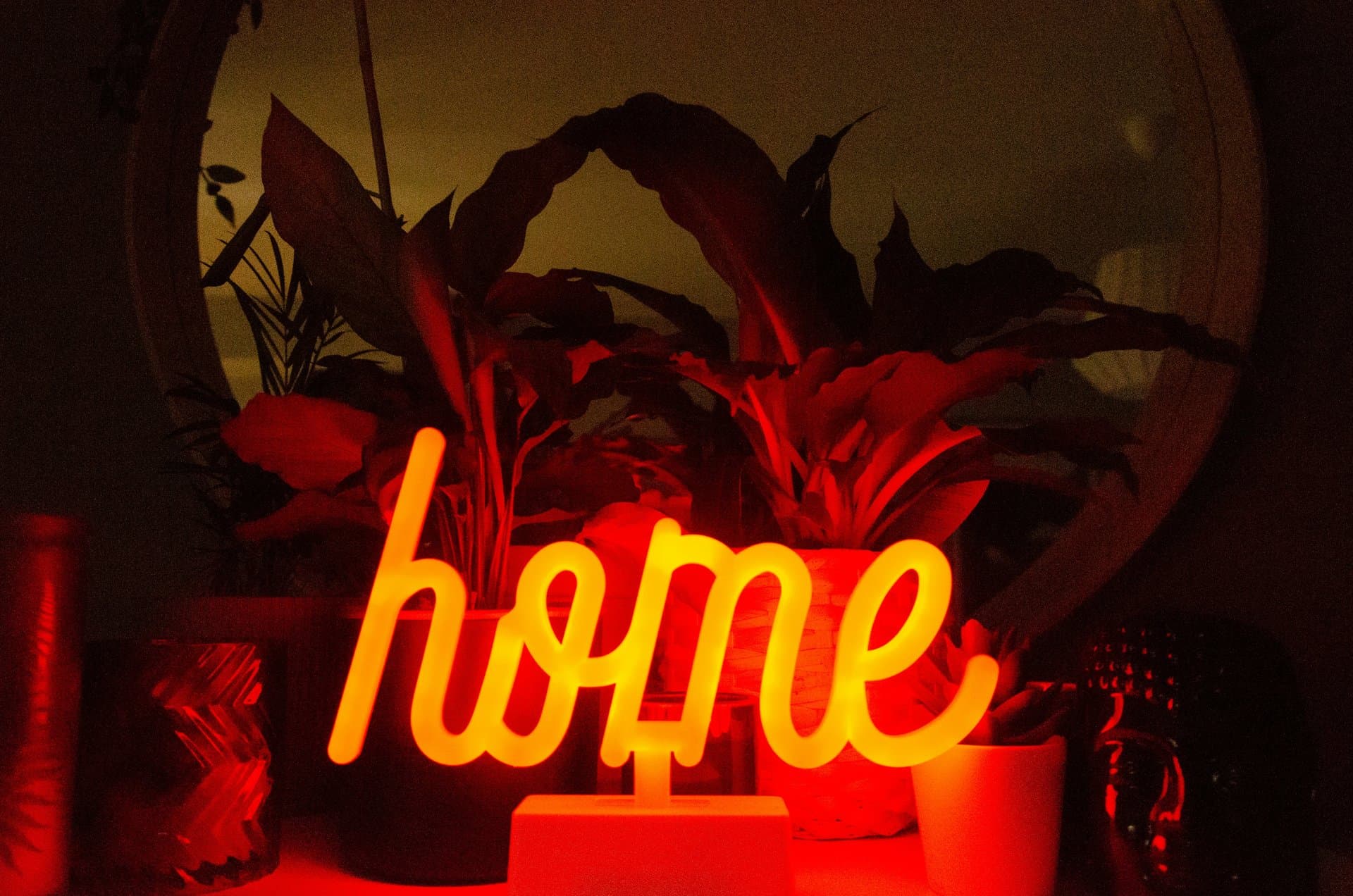 a neon sign saying 'home'