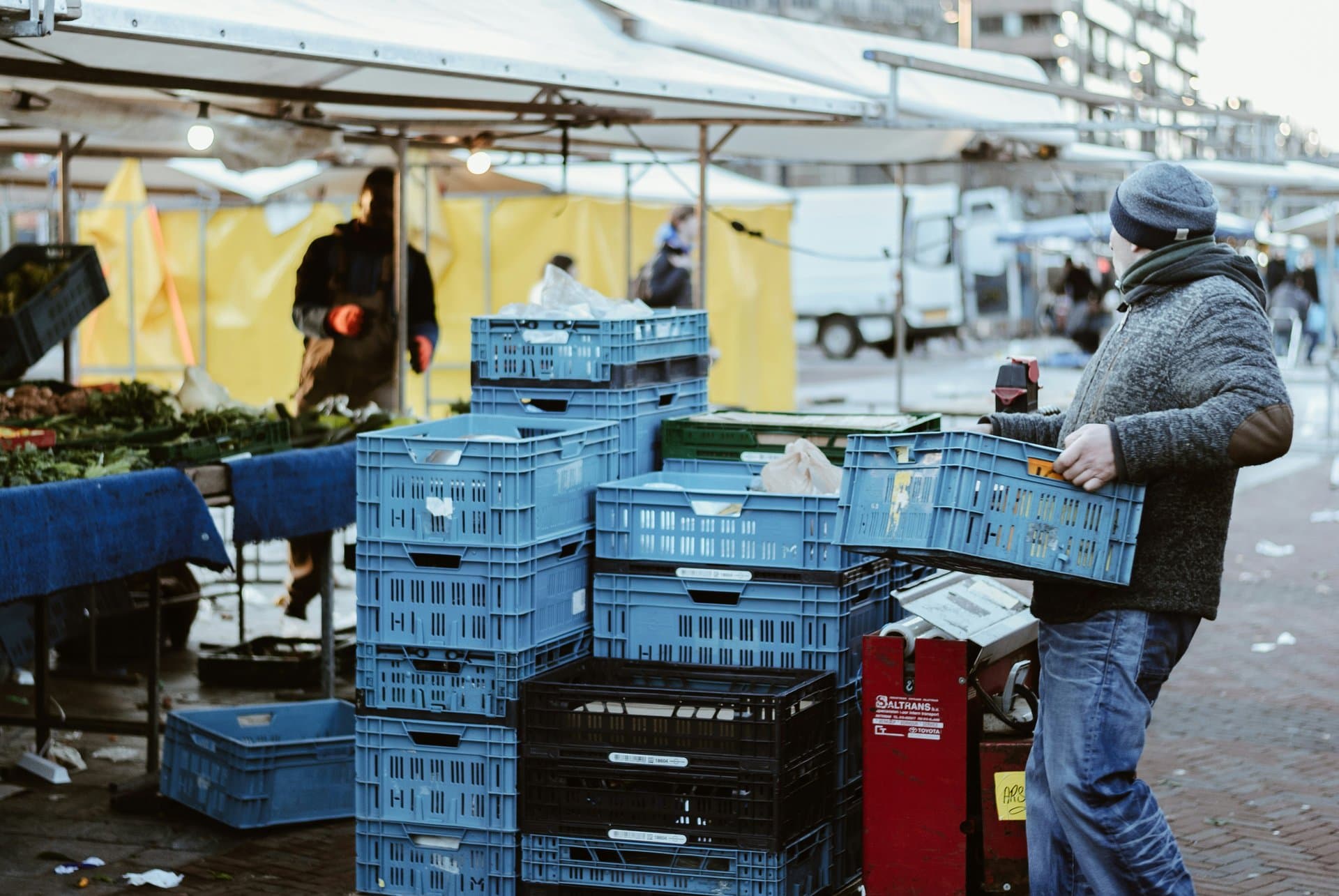 man lifting a cart at market
