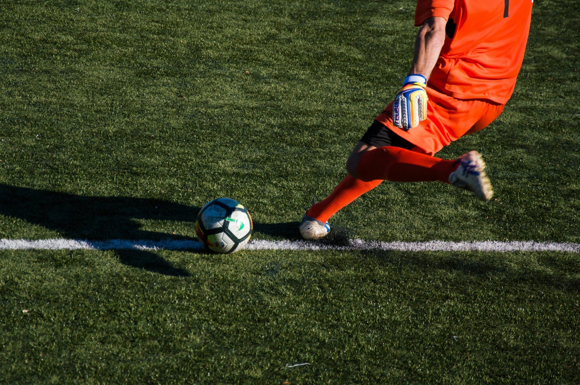 a footballer kicking the ball